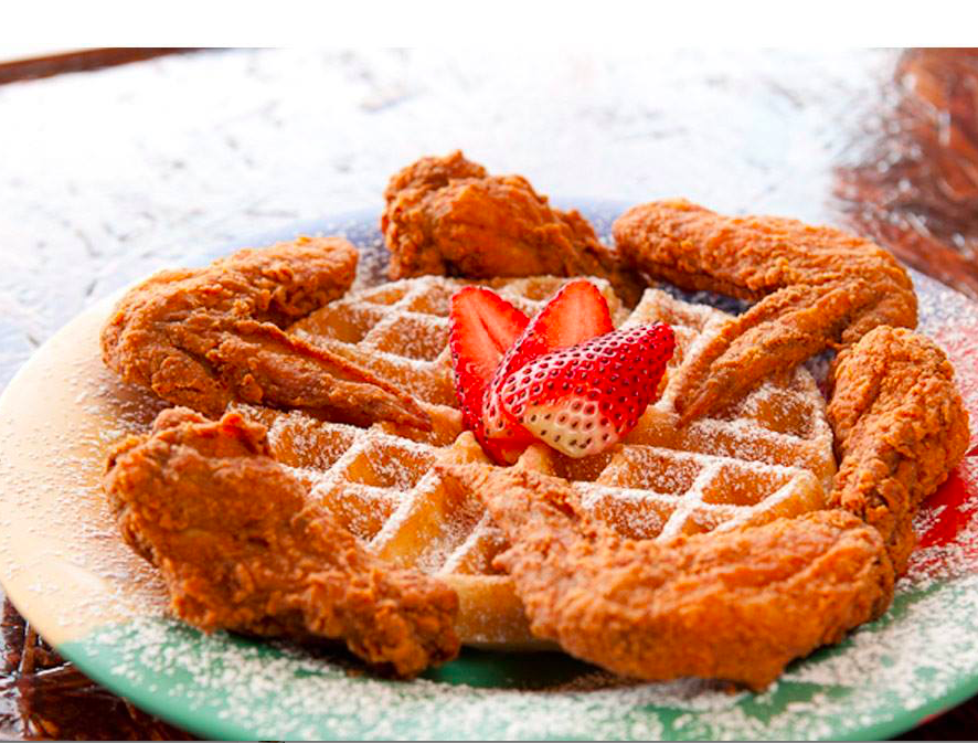 The Breakfast Klub’s chicken and waffles with strawberries.