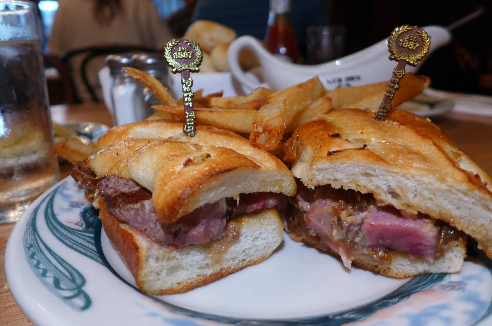 A steak sandwich on a baguette.