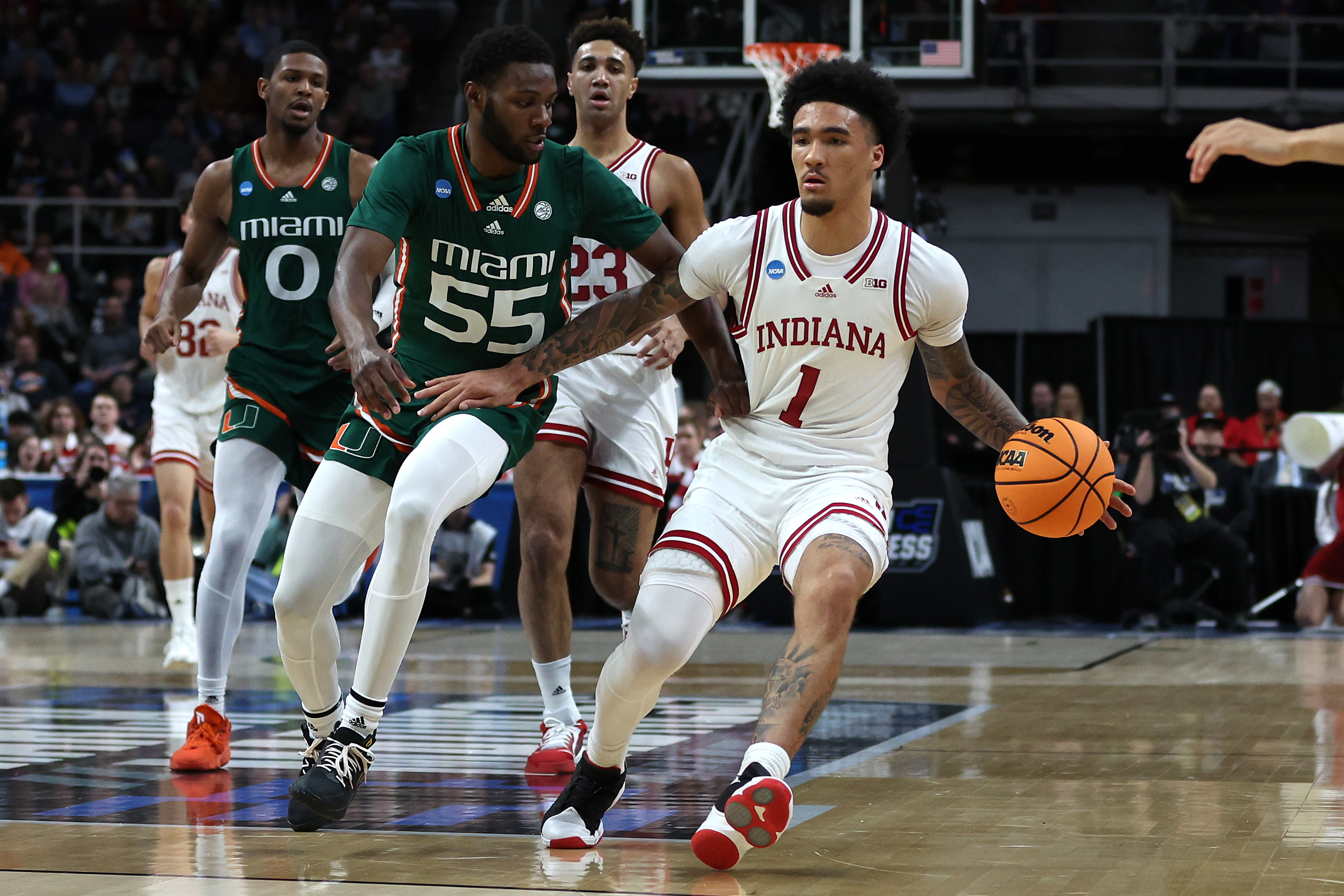 ALBANY, NEW YORK - MARCH 19: Jalen Hood-Schifino #1 of the Indiana Hoosiers handles the ball against Wooga Poplar #55 of the Miami Hurricanes in the first half during the second round of the NCAA Men’s Basketball Tournament at MVP Arena on March 19, 2023 in Albany, New York.