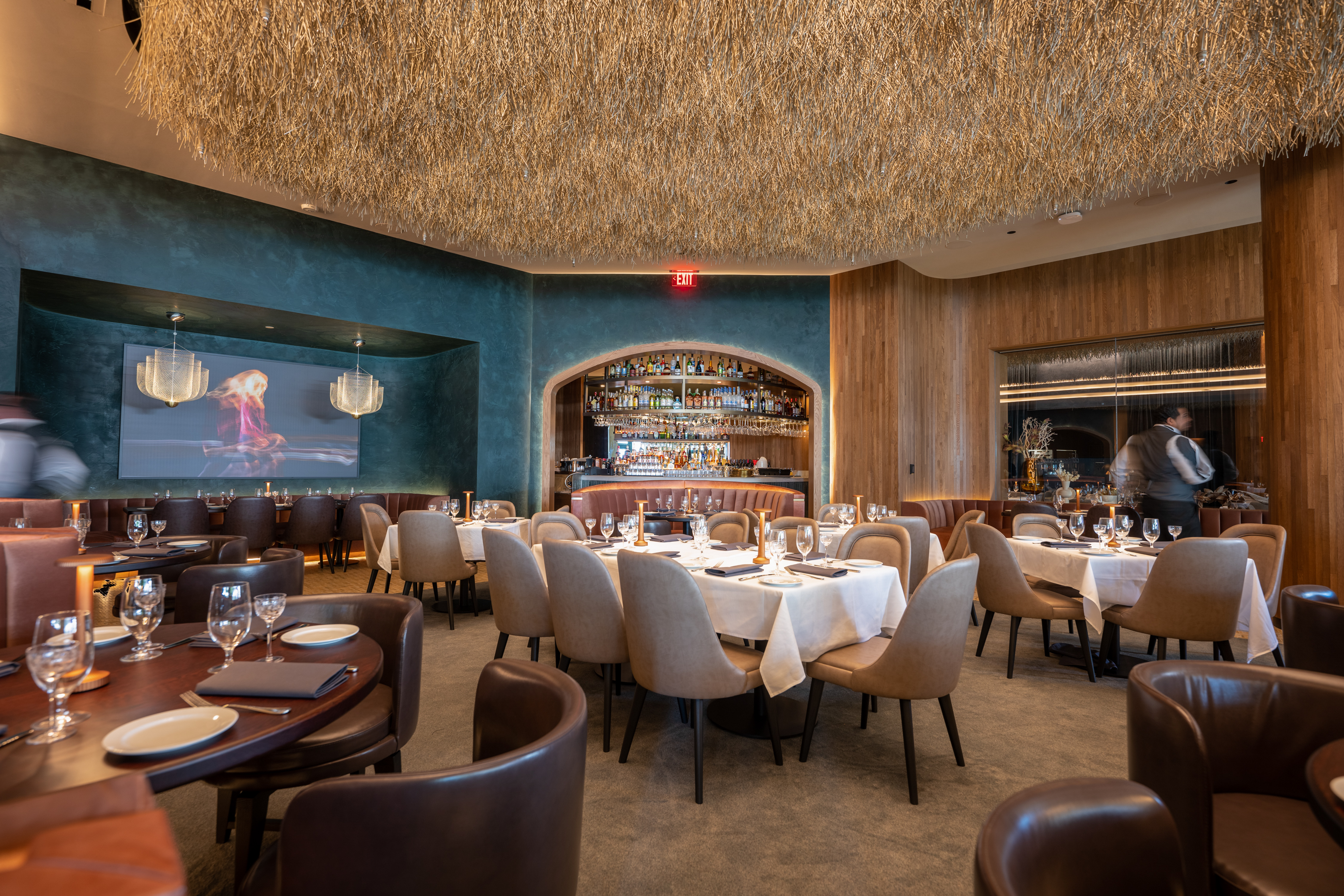 A dining room with blue walls at Ocean Prime.