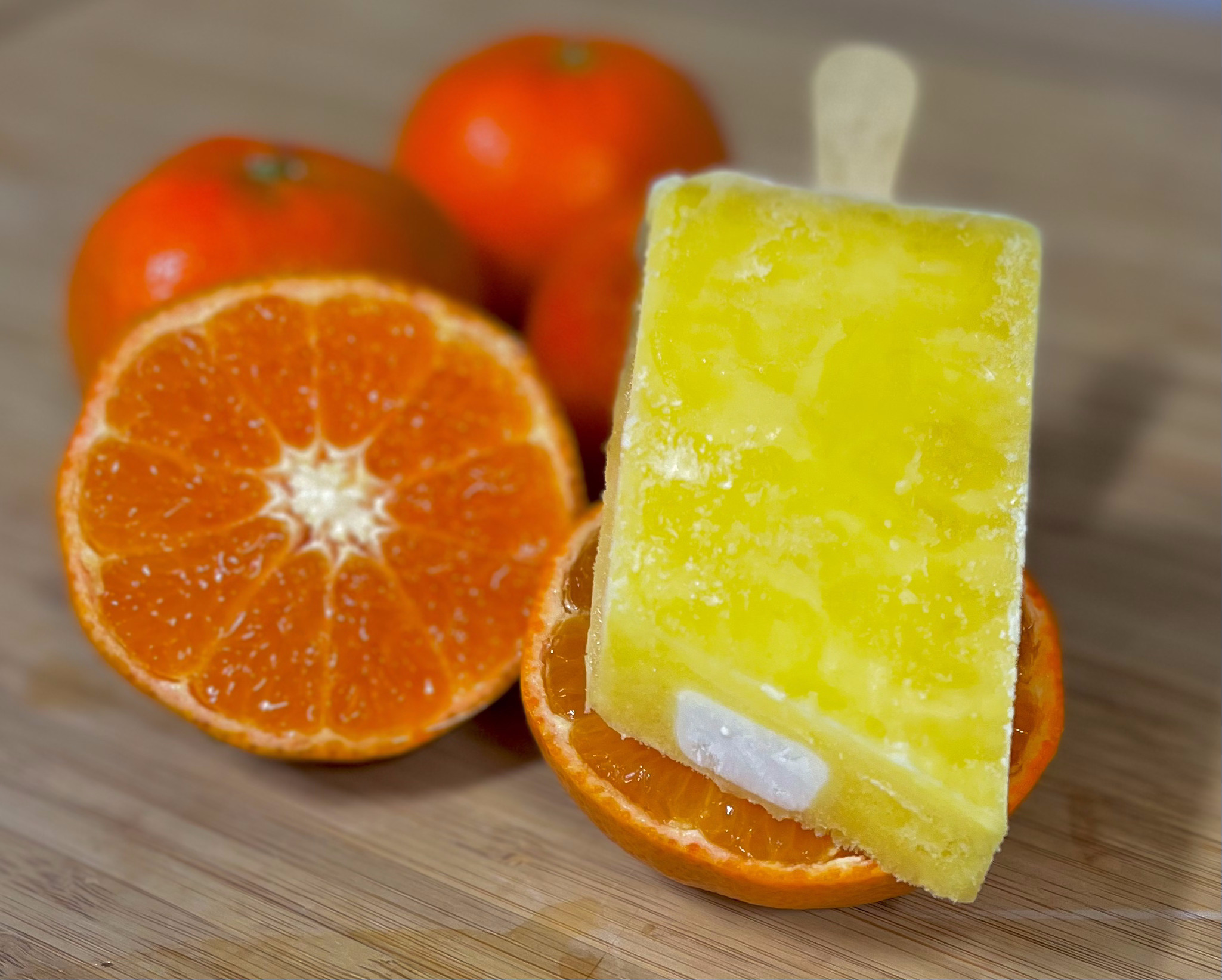 A shot of a frozen pop with oranges.