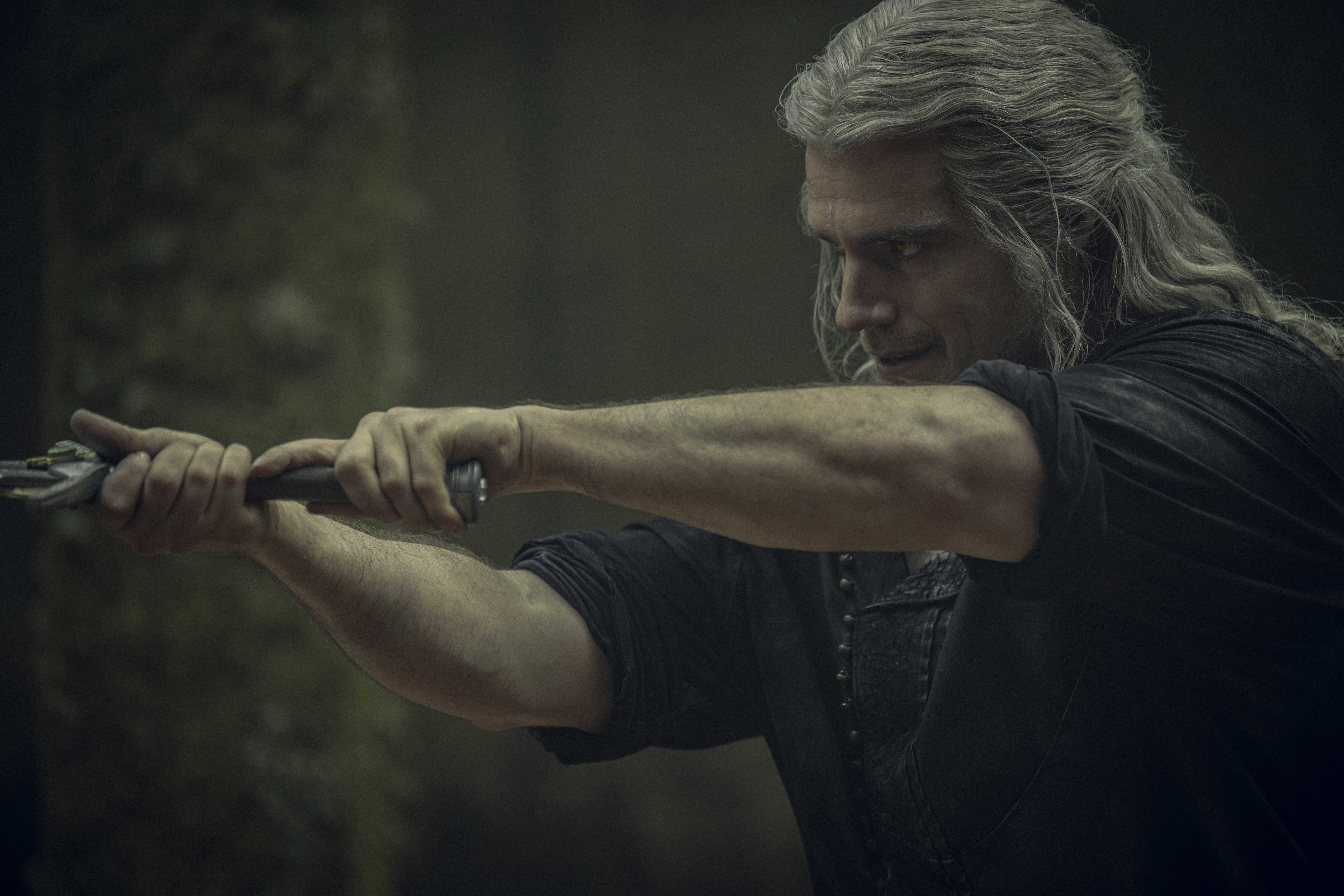Henry Cavill as Geralt in Netflix’s The Witcher, holding a sword