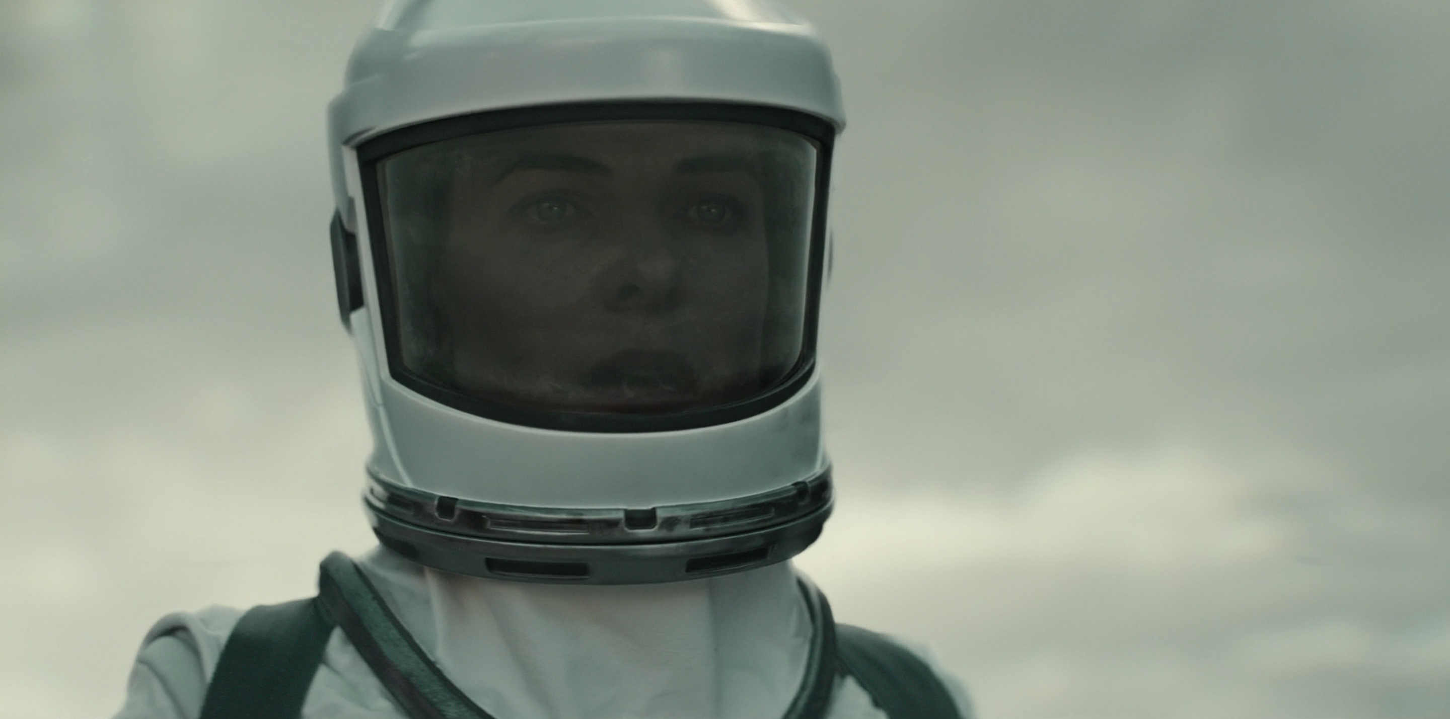 Juliette (Rebecca Ferguson) staring down something in disbelief wearing a spacesuit