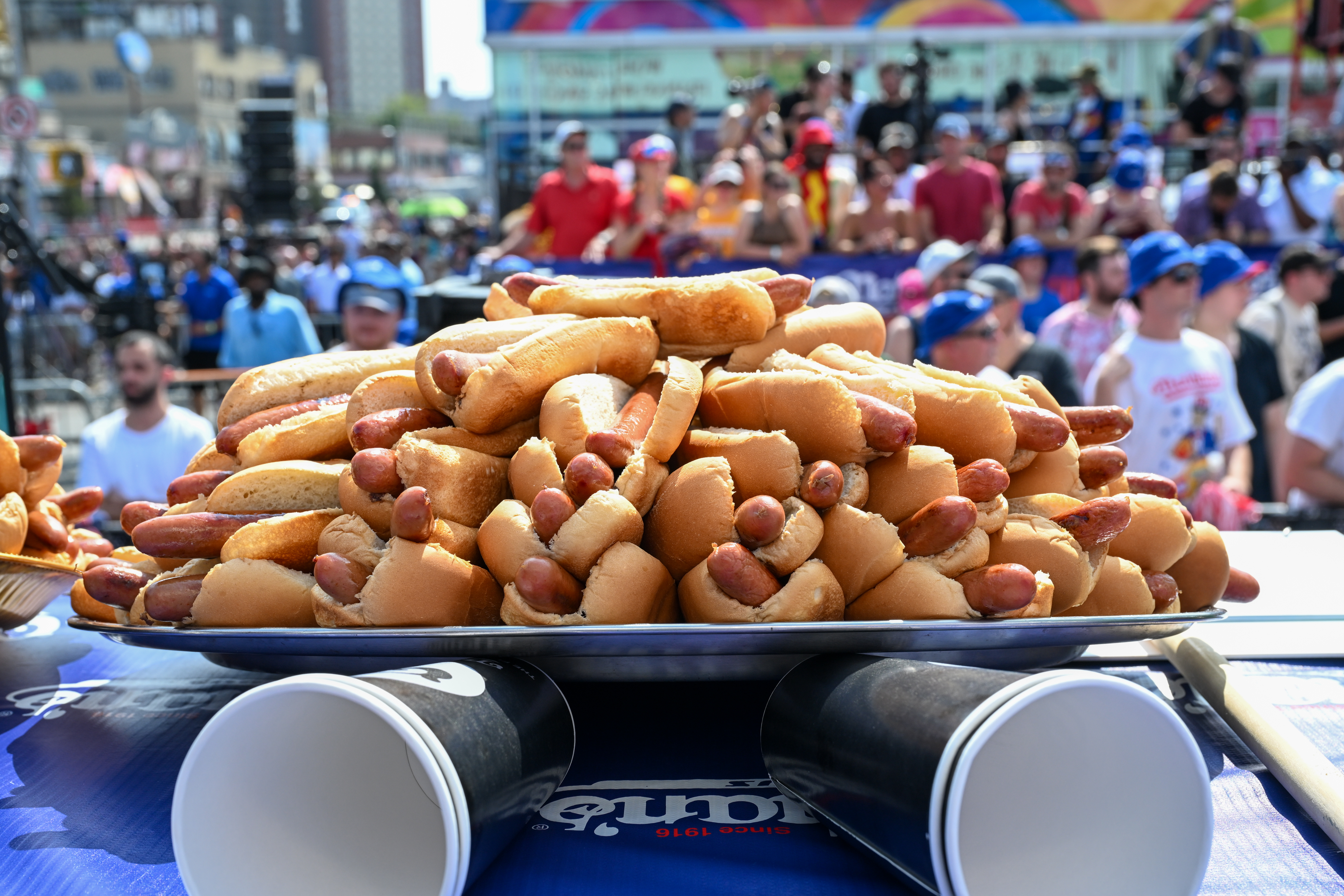 Hot dogs are placed on the competition table ahead of the 2023 Nathan’s Famous Fourth of July International Hot Dog Eating Contest at Coney Island on July 04, 2023 in the Brooklyn borough of New York City. The annual contest, which began in 1972, draws thousands of spectators to Nathan’s Famous located on Surf Avenue.