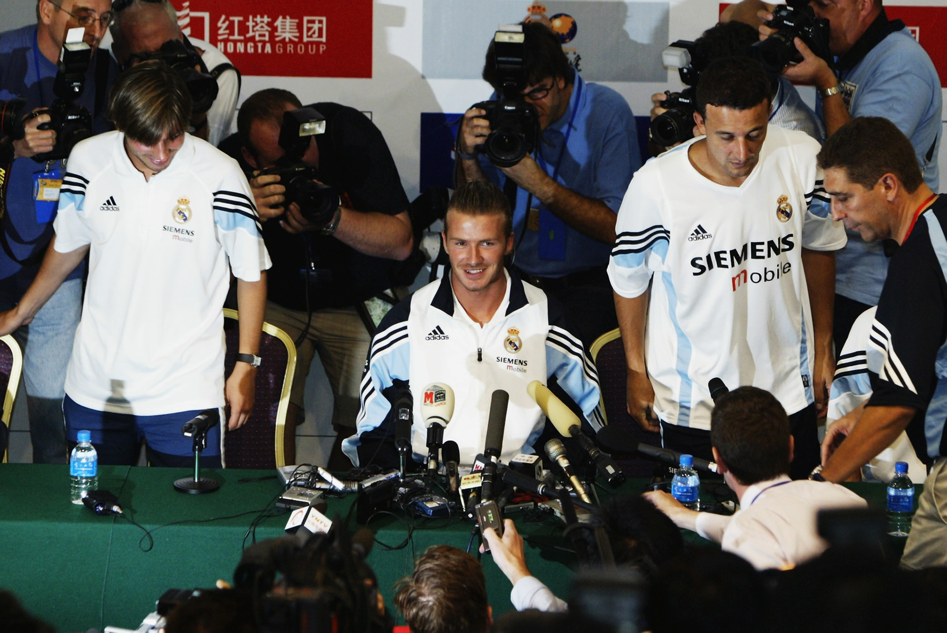 David Beckham of Real Madrid is mobbed by the media as he arrives for his first press conference
