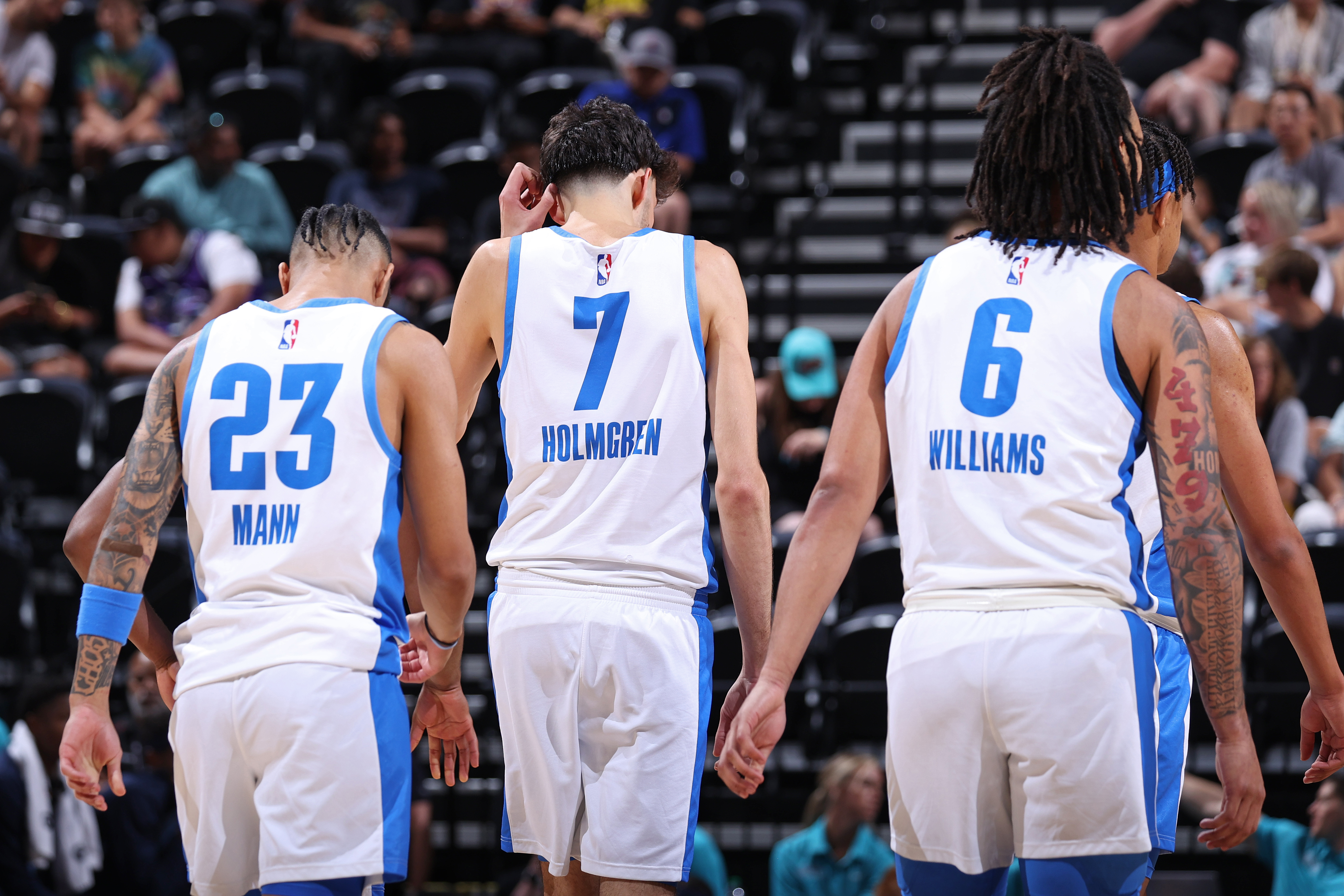 Tre Mann, Chet Holmgren and Jaylin Williams of the Oklahoma City Thunder look on during the game against the Memphis Grizzlies during the 2023 NBA Salt Lake City Summer League on July 5, 2023 at the Delta Center in Salt Lake City, Utah.&nbsp;