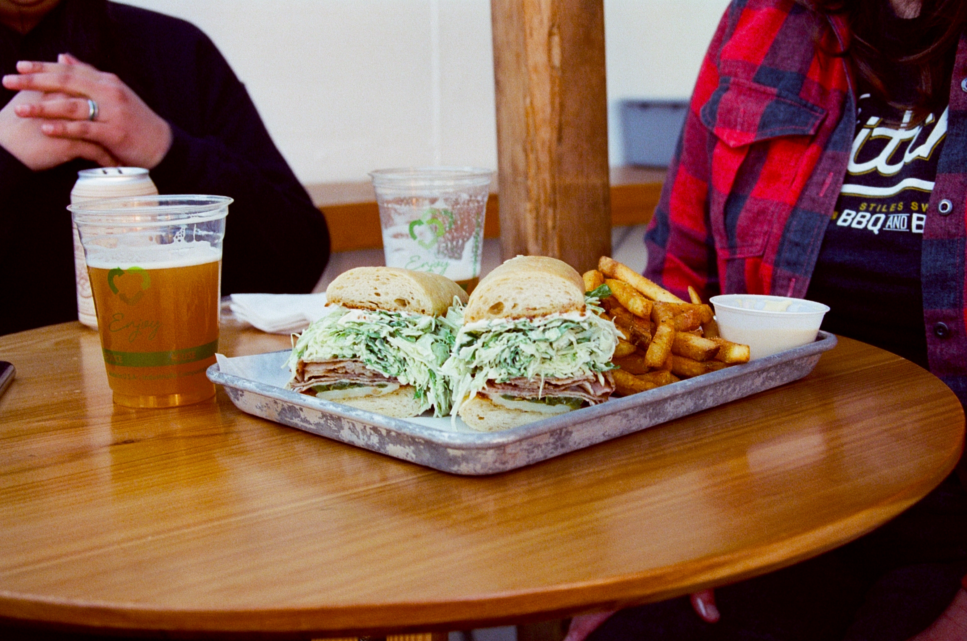 A grilled Dos Hermanos Bakery baguette with house-brined and smoked pork loin, cabbage-arugula slaw, provolone, and grilled jalapenos at Sammich in Portland, Oregon.