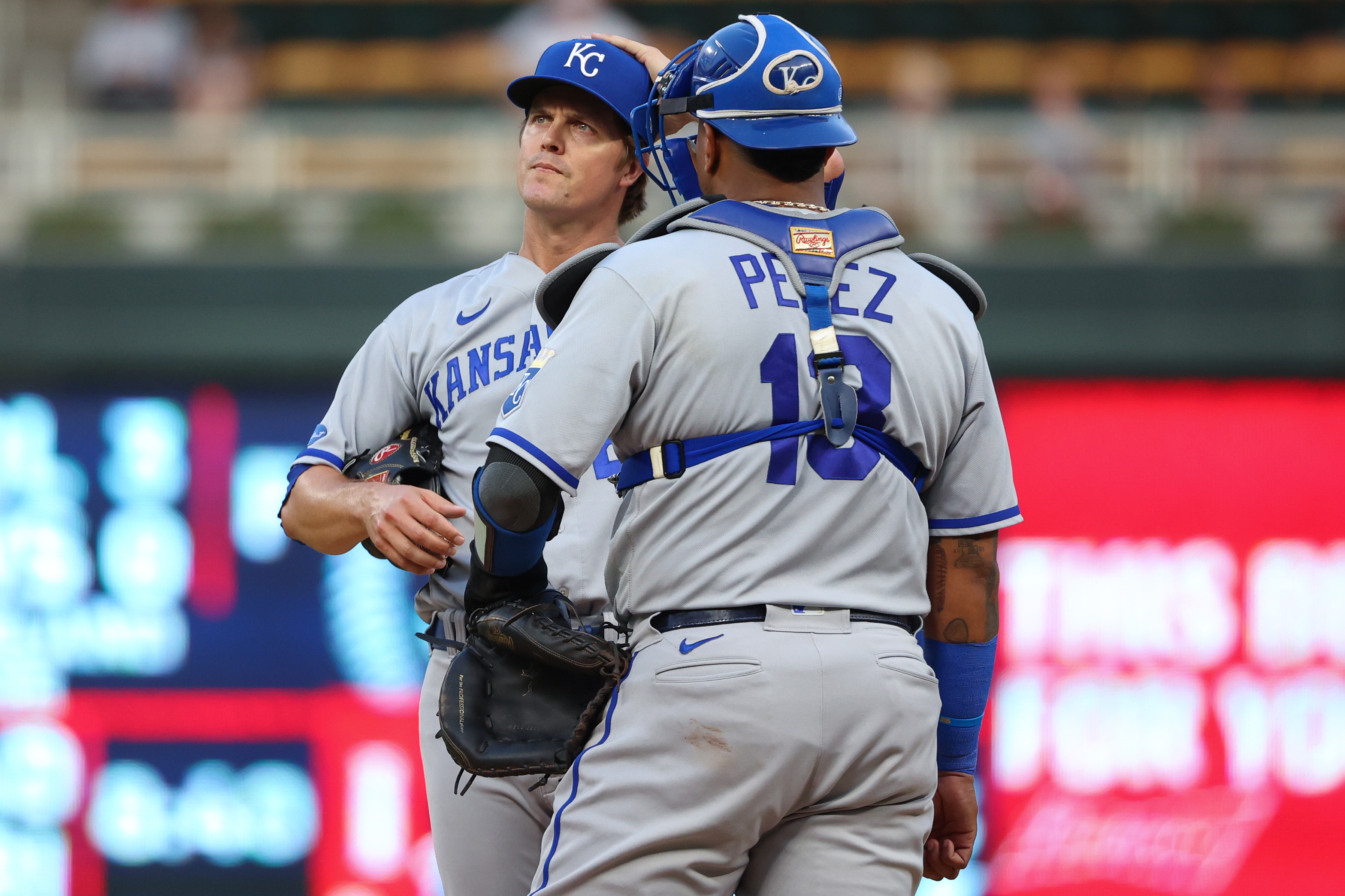 Salvador Perez #13 of the Kansas City Royals talks to Zack Greinke #23 against the Minnesota Twins during a mound visit in the first inning of the game at Target Field on September 14, 2022 in Minneapolis, Minnesota.