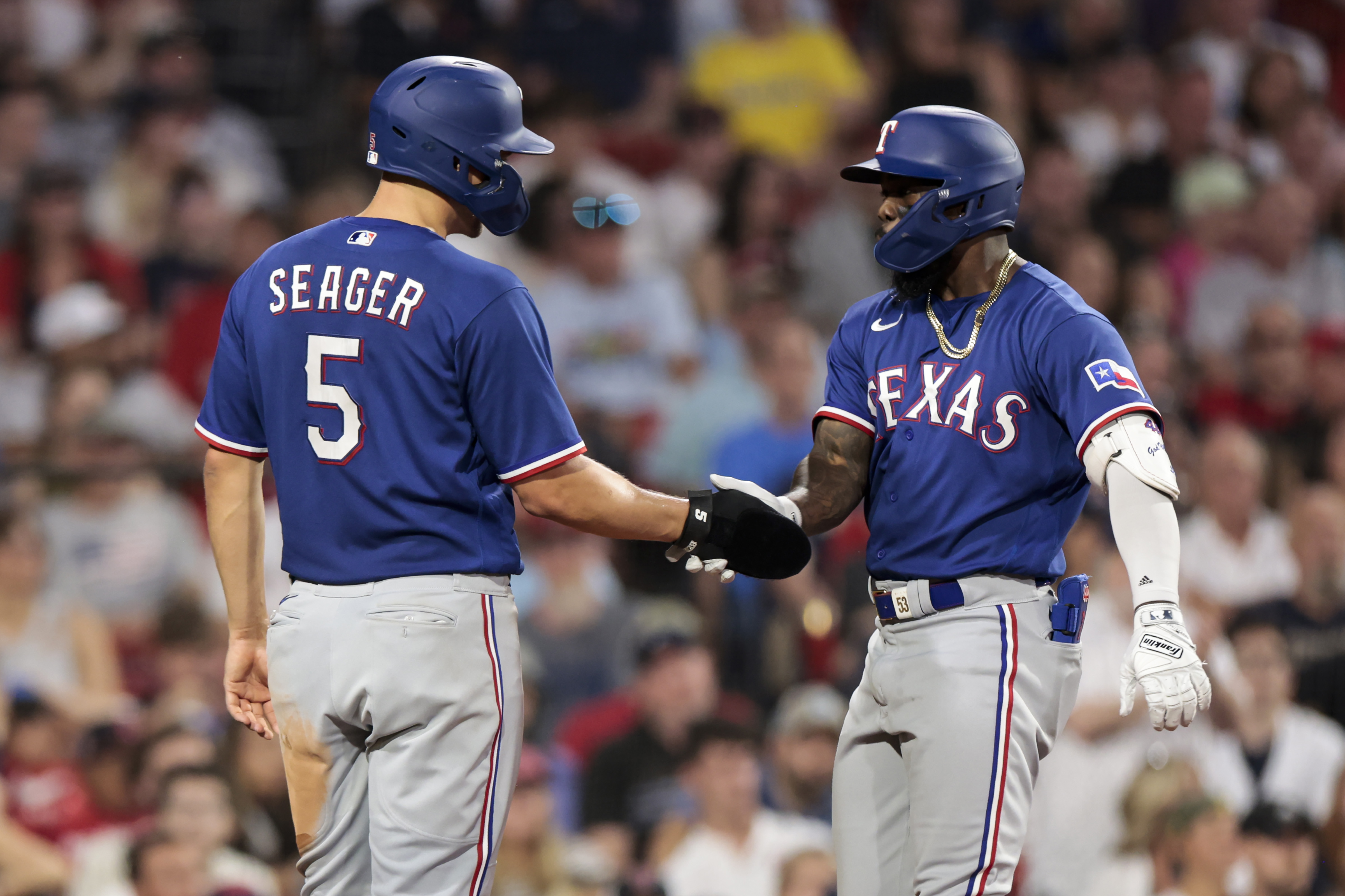 Adolis Garcia of the Texas Rangers reacts with Corey Seager of the Texas Rangers after hitting a two run home run during the sixth inning against the Boston Red Sox at Fenway Park on July 05, 2023 in Boston, Massachusetts.