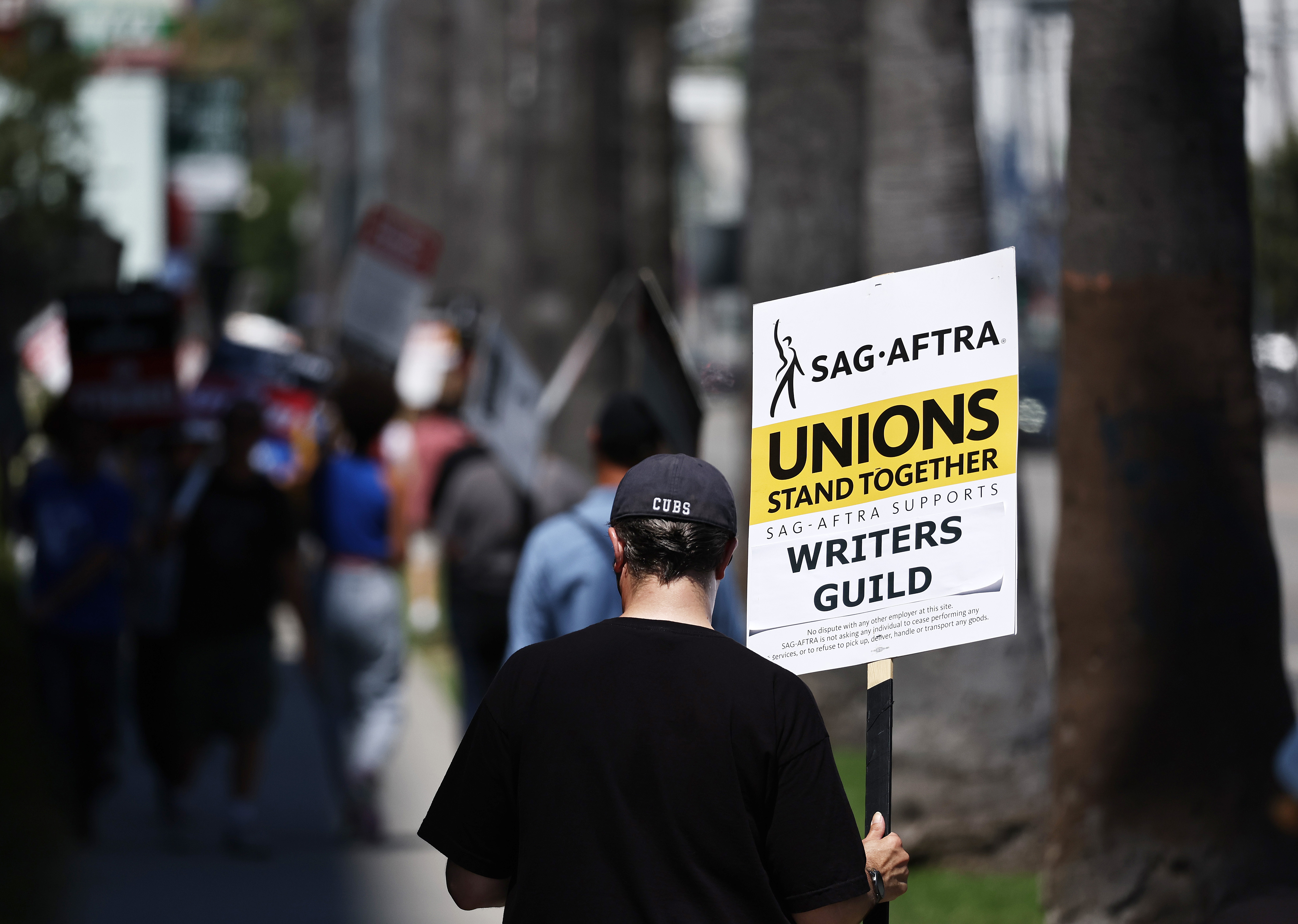 A protester holding a sign that read, “SAG-AFTRA unions stand together.”