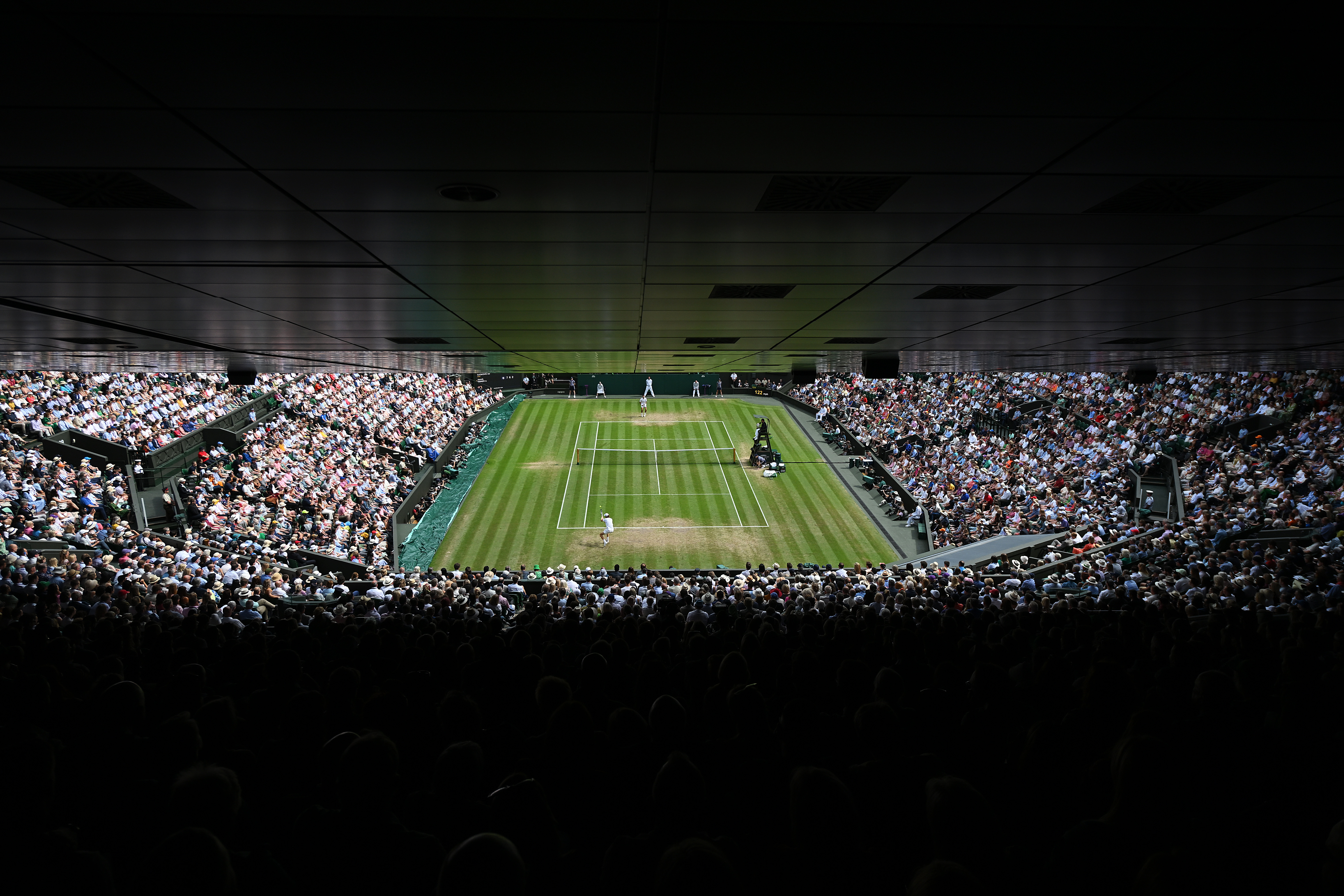 A general view as Jannik Sinner of Italy plays a forehand against Novak Djokovic of Serbia during their Men’s Singles Quarter Final match on day nine of The Championships Wimbledon 2022 at All England Lawn Tennis and Croquet Club on July 05, 2022 in London, England.