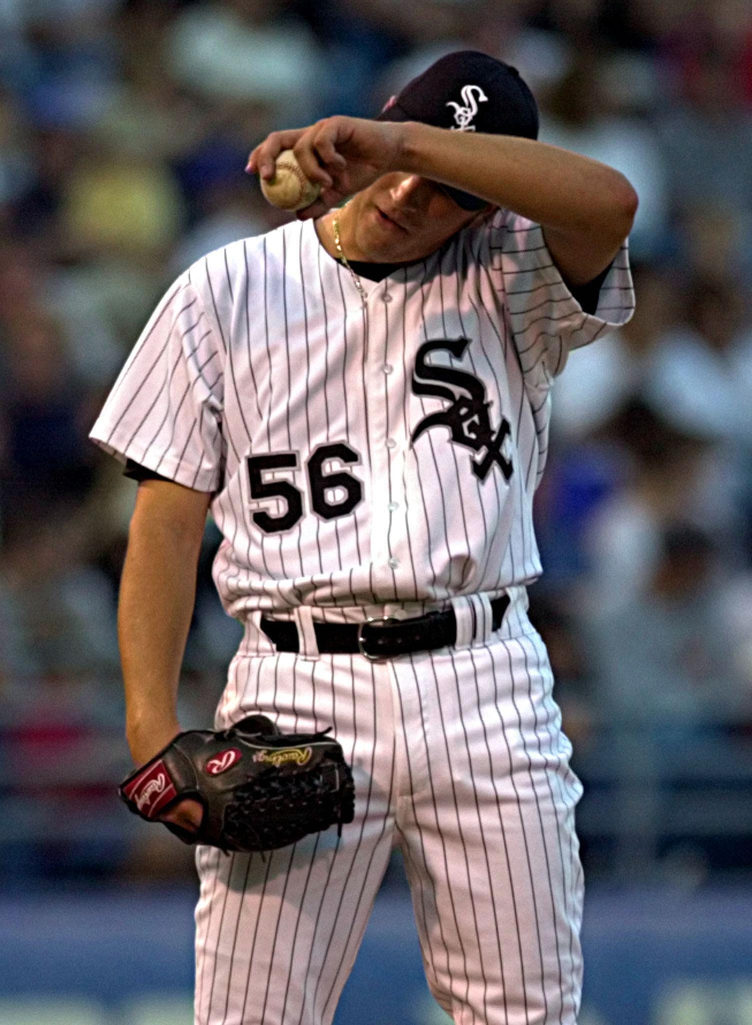 Chicago White Sox pitcher Mark Buehrle wipes his f