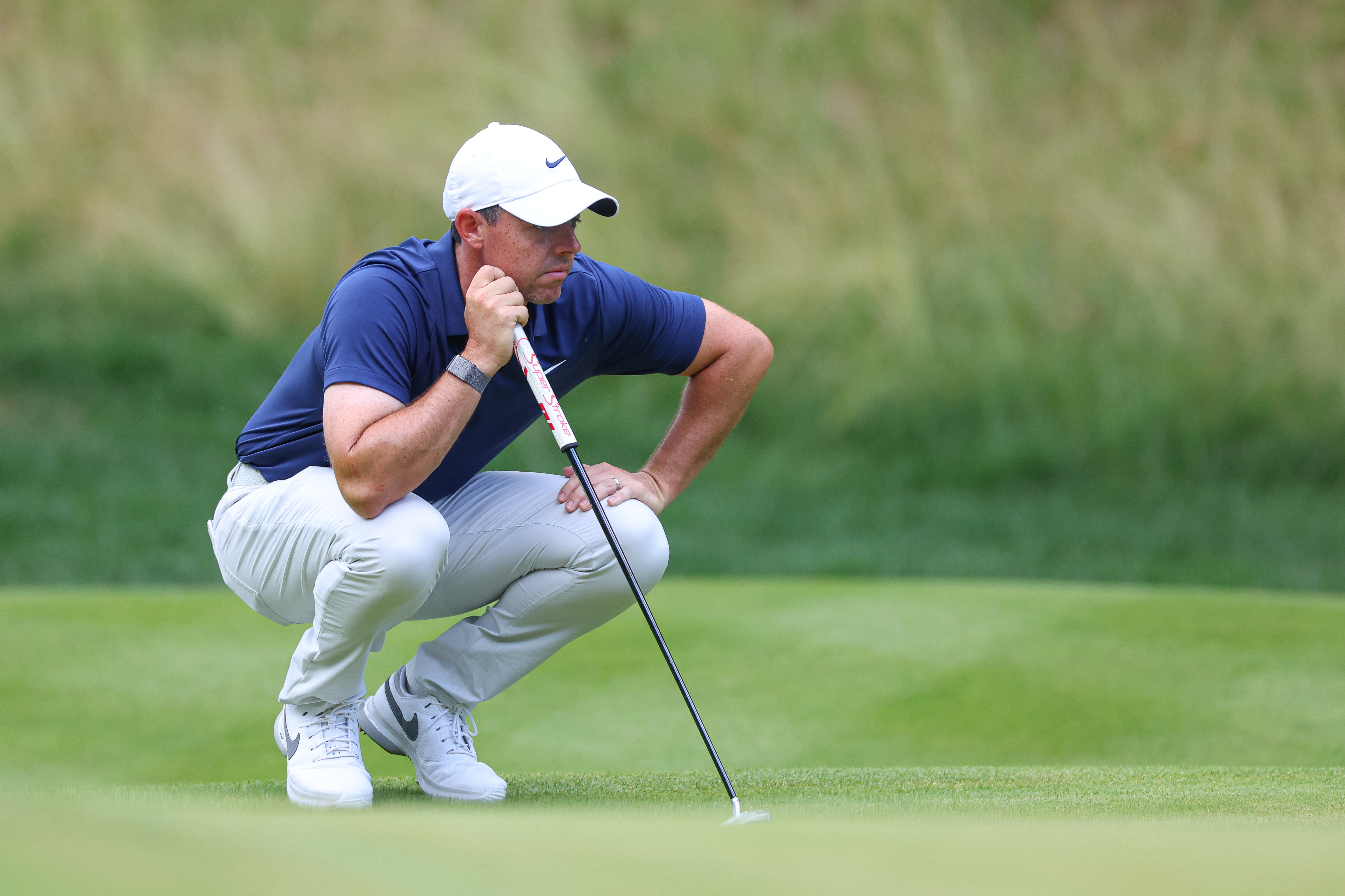 Rory McIlroy looks over his putt on the 14th green during the final round of the Travelers Championship golf tournament.
