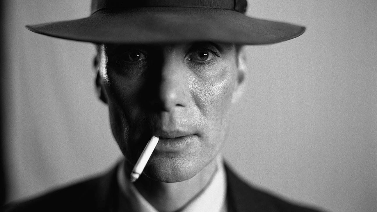 A black-and-white close-up of Cillian Murphy in a suit and hat, cigarette dangling from his mouth.