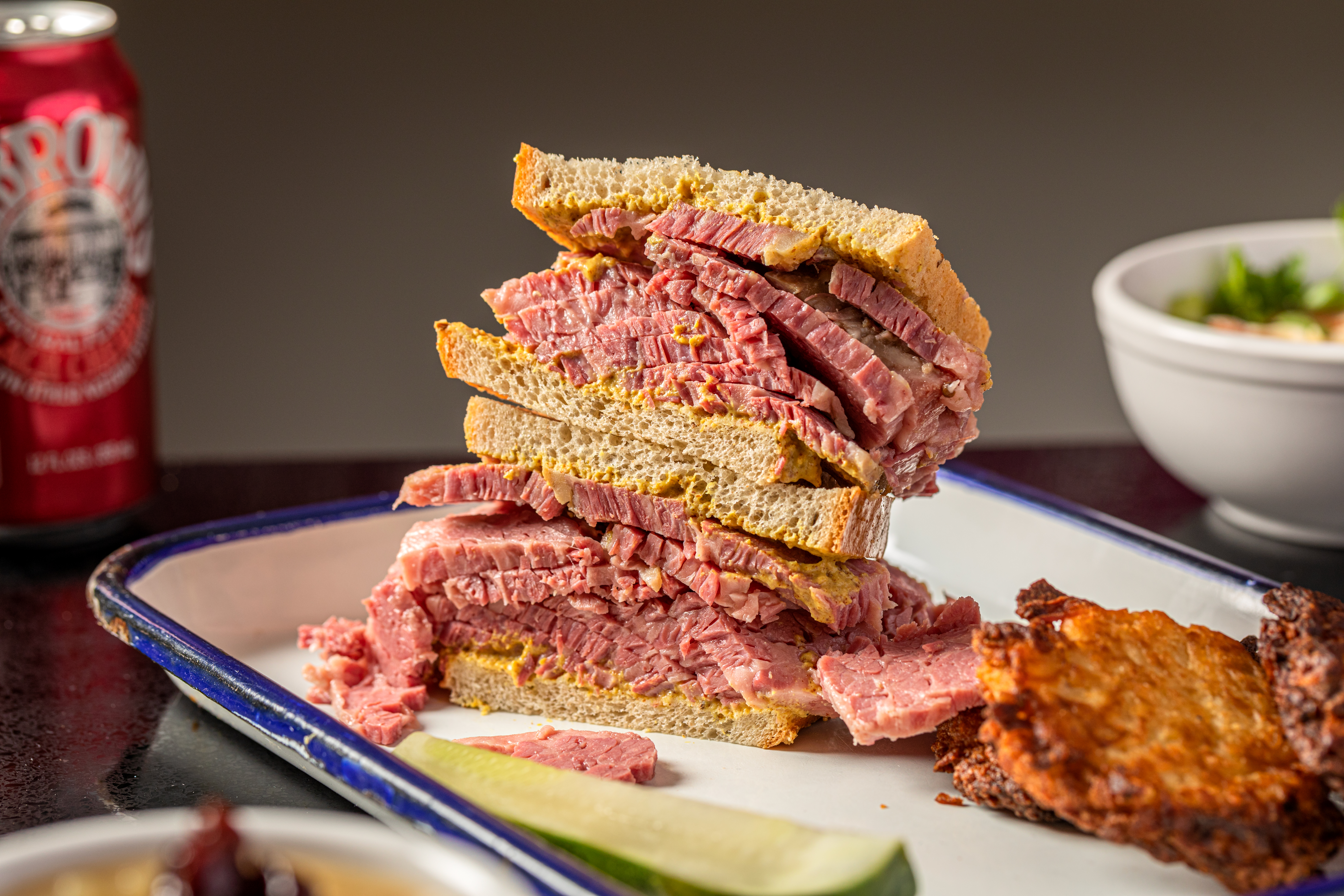 A tray with a halved corned beef sandwich.