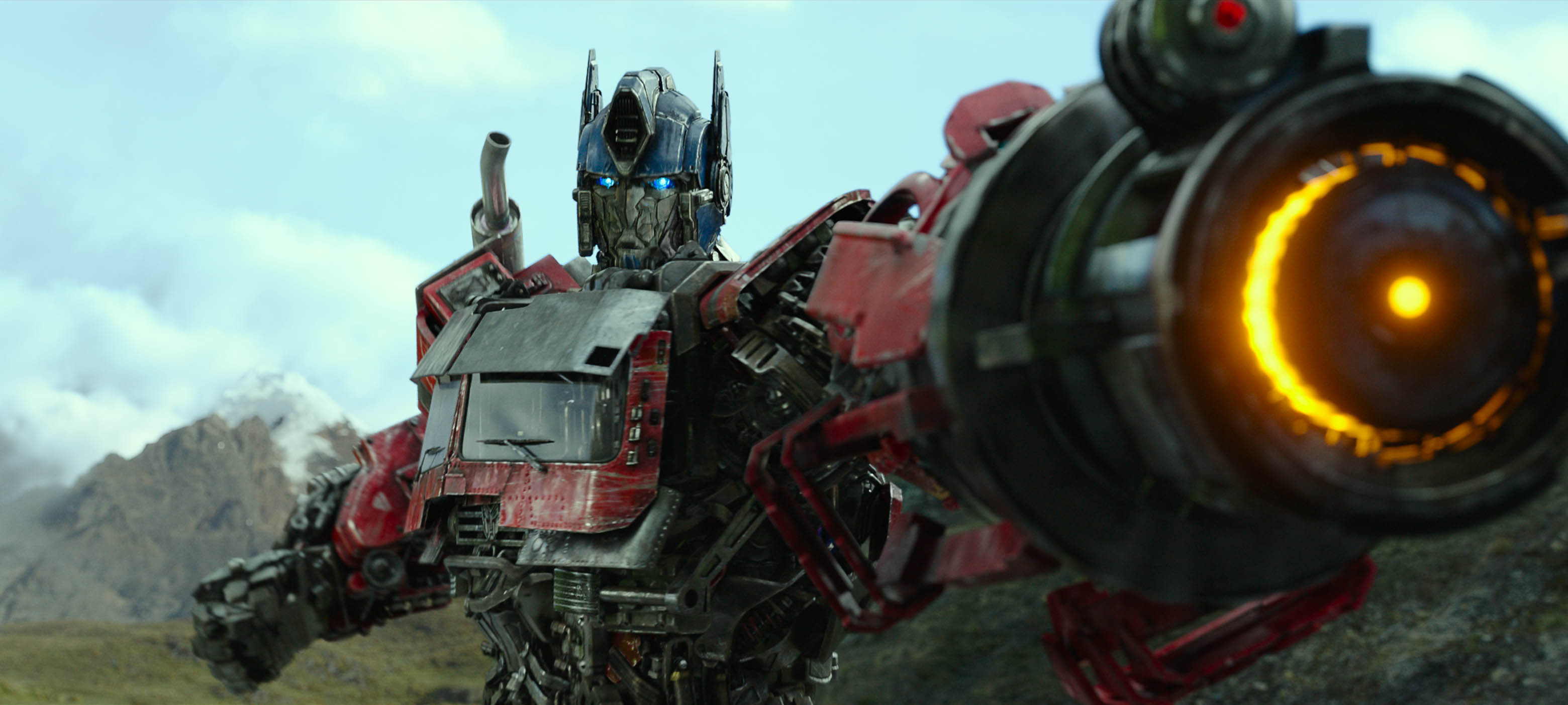 Optimus Prime holds up his big gun arm in Transformers: Rise of the Beasts