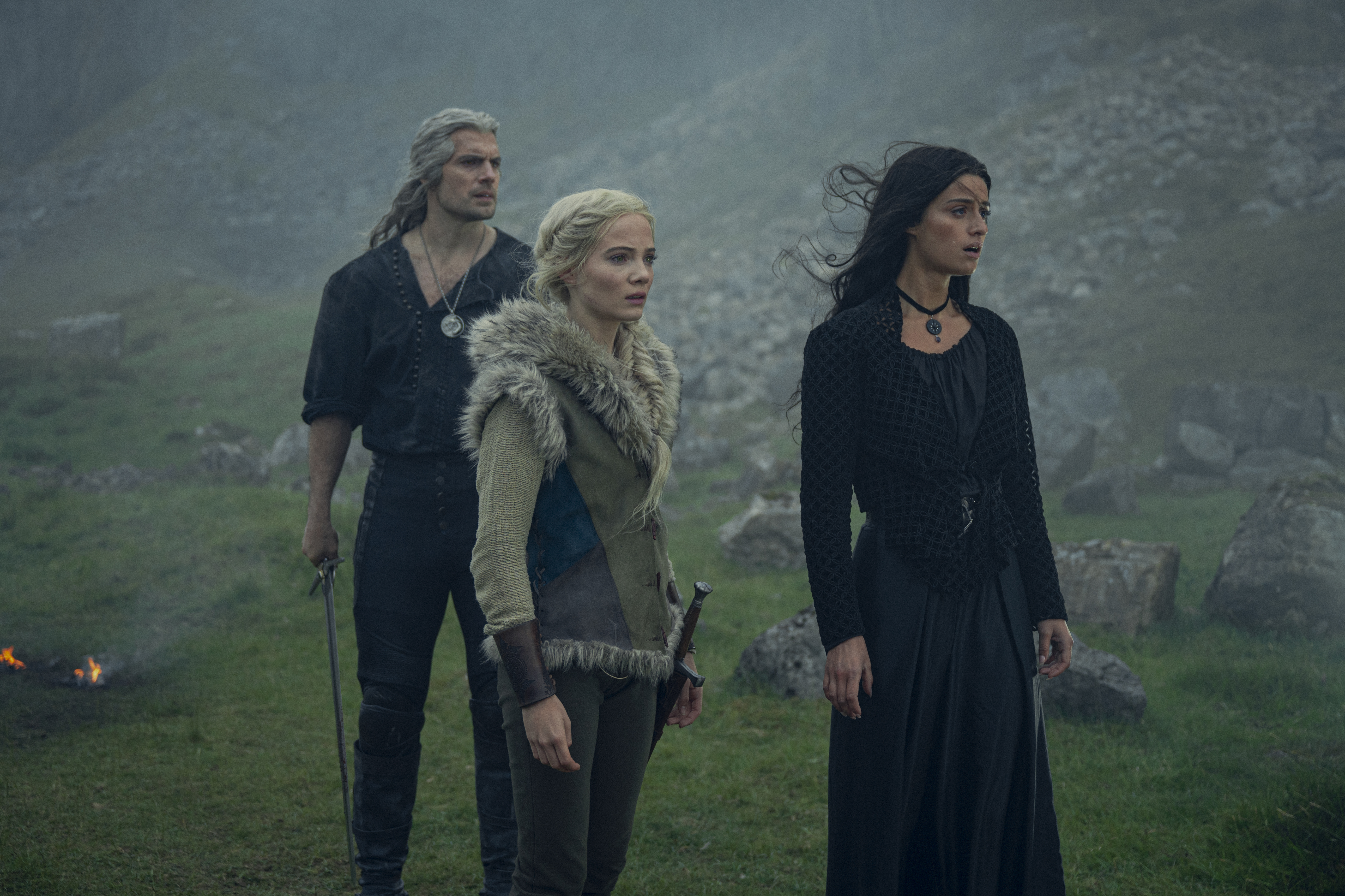 Geralt, Ciri and Yennefer stand in a rocky field in season 3 of The Witcher