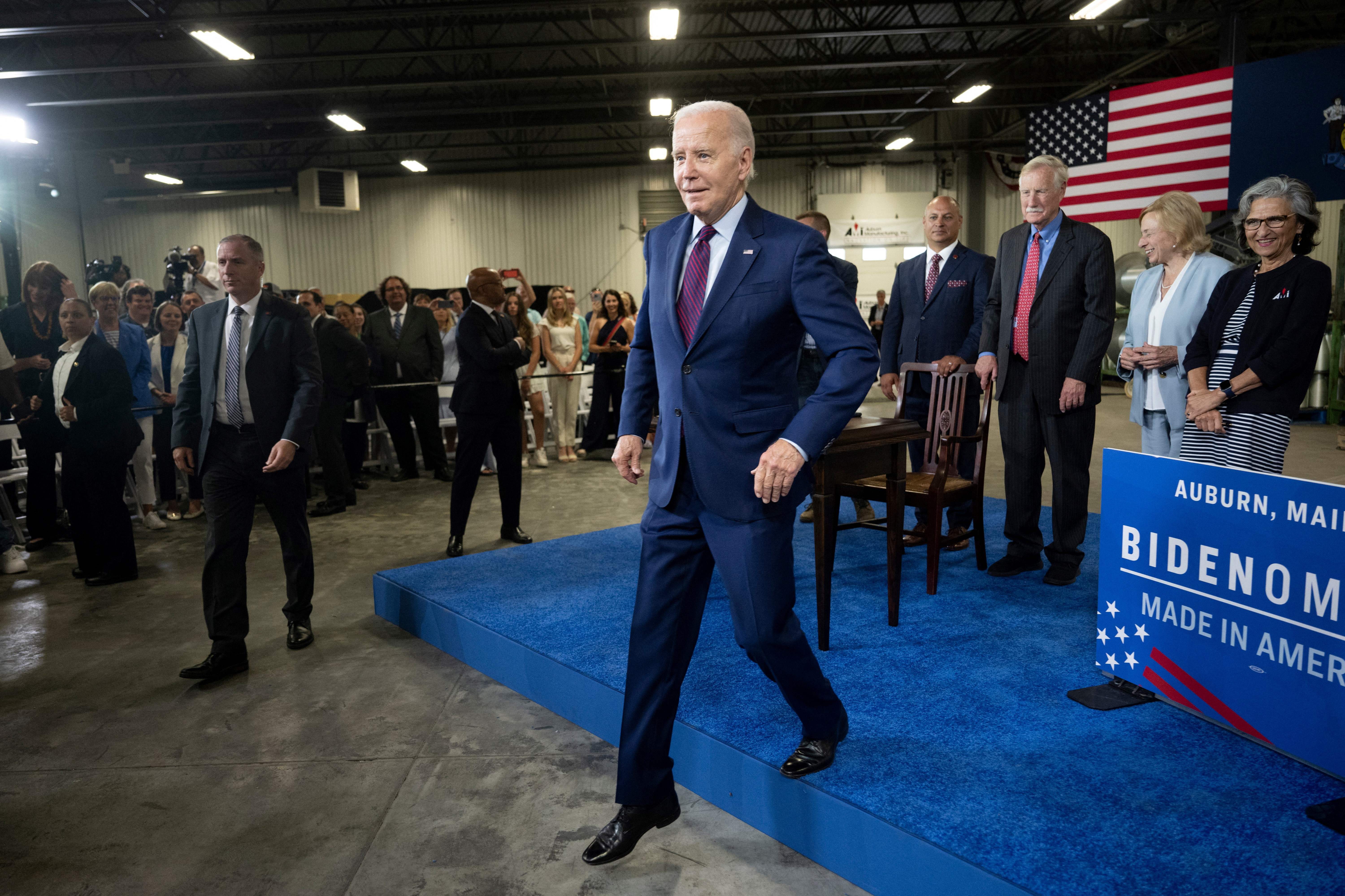 Joe Biden walking off of a stage.