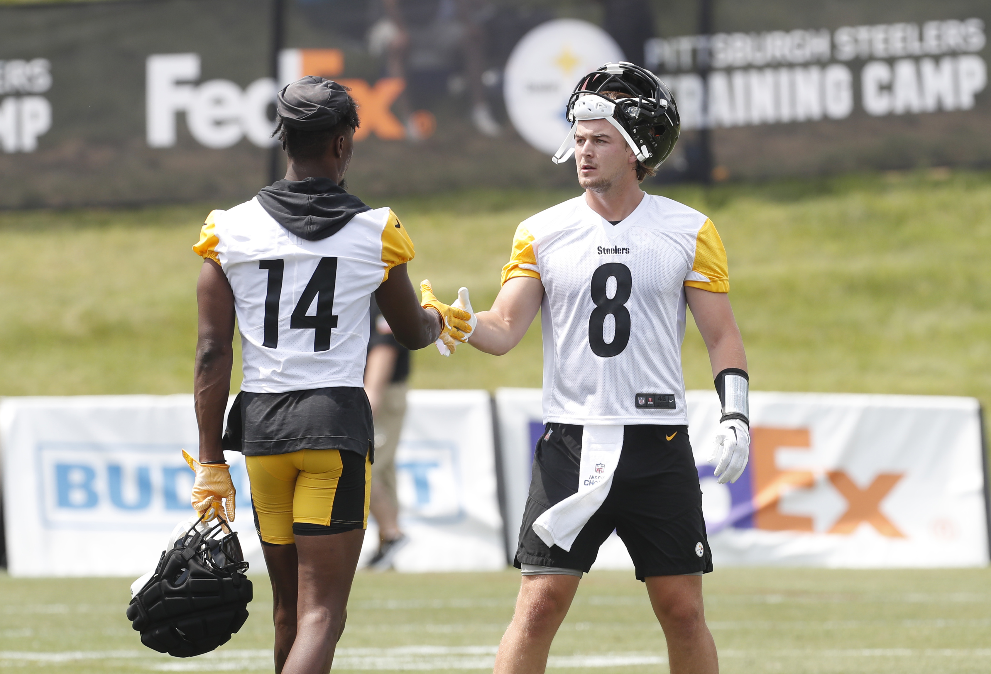 Pittsburgh Steelers wide receiver George Pickens (14) and quarterback Kenny Pickett (8) react between drills during training camp at Saint Vincent College.