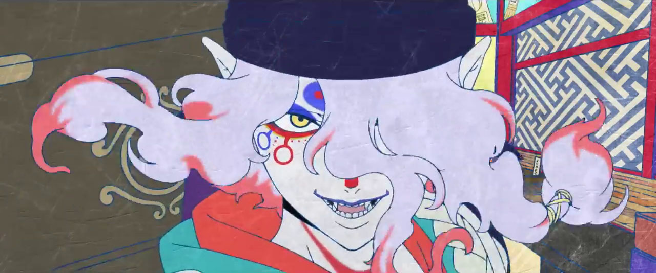 A pale-faced anime man with pink and red hair, with strange symbols and fanged teeth smiling in the trailer for the Mononoke movie.
