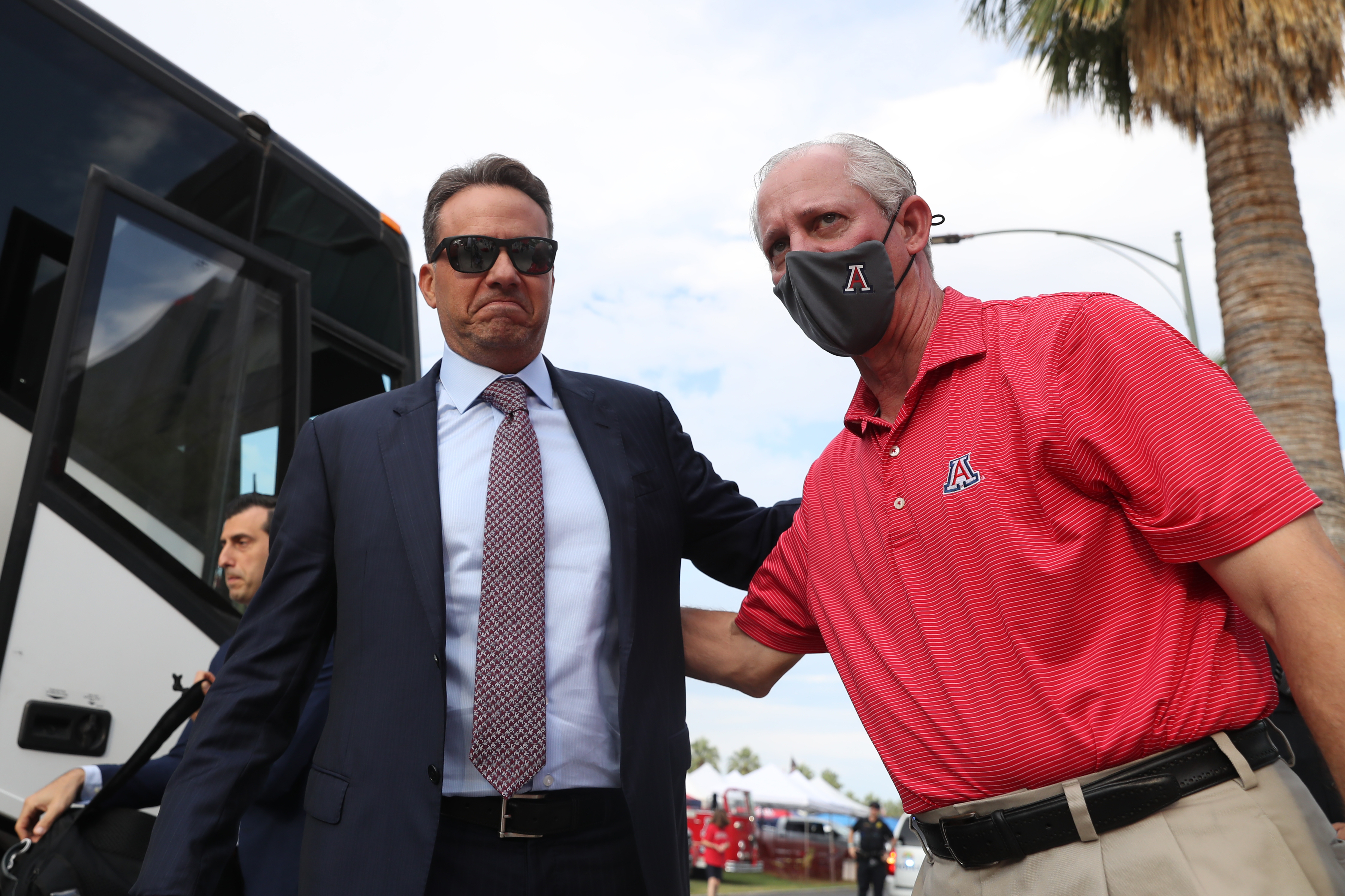 Arizona president Robert Robbins, masked, with Arizona head coach Jedd Fisch from September, 2021