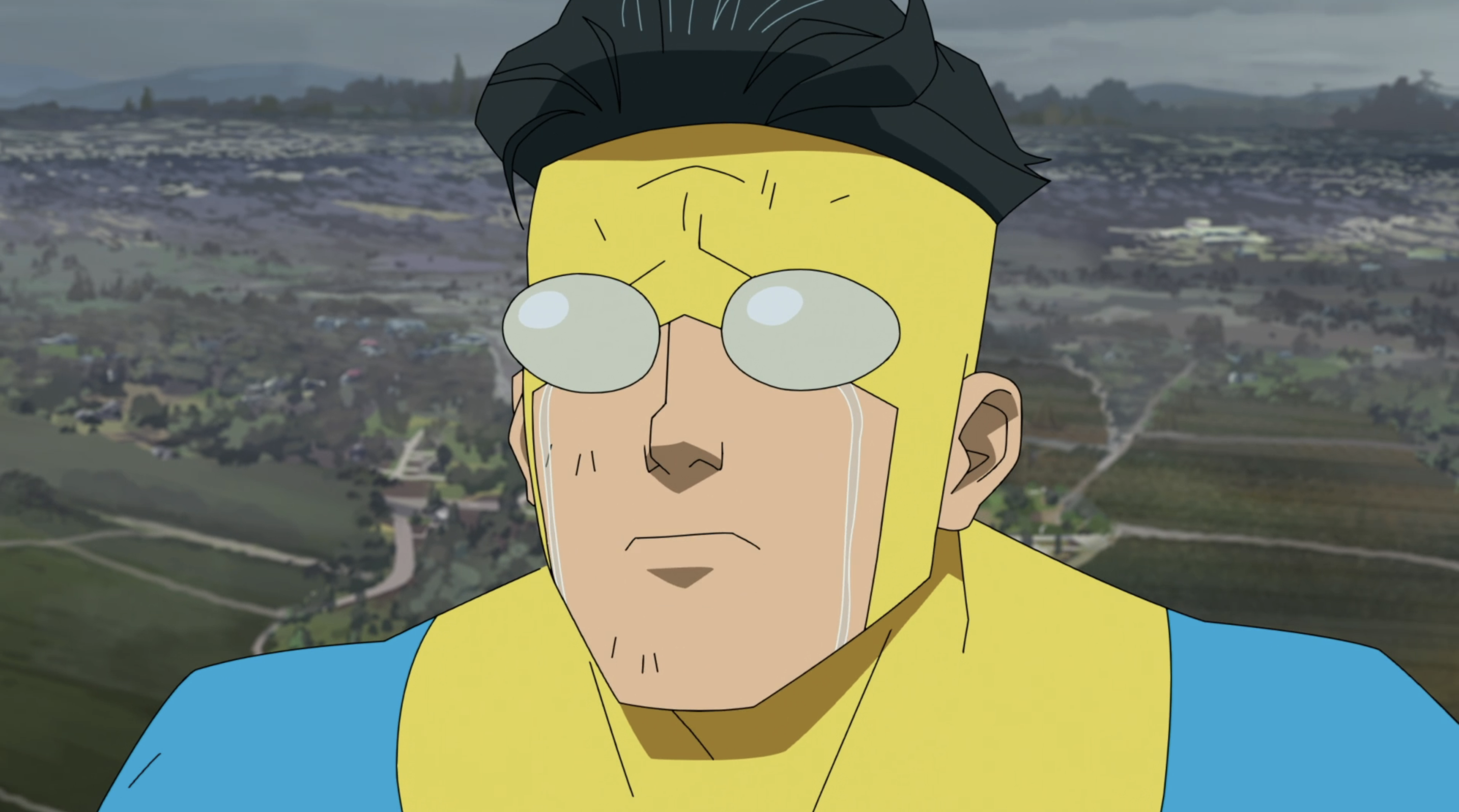 Mark Grayson, a dark-haired young man in a sky-blue and yellow spandex super-suit, cries in closeup in season 1 of the animated series Invincible