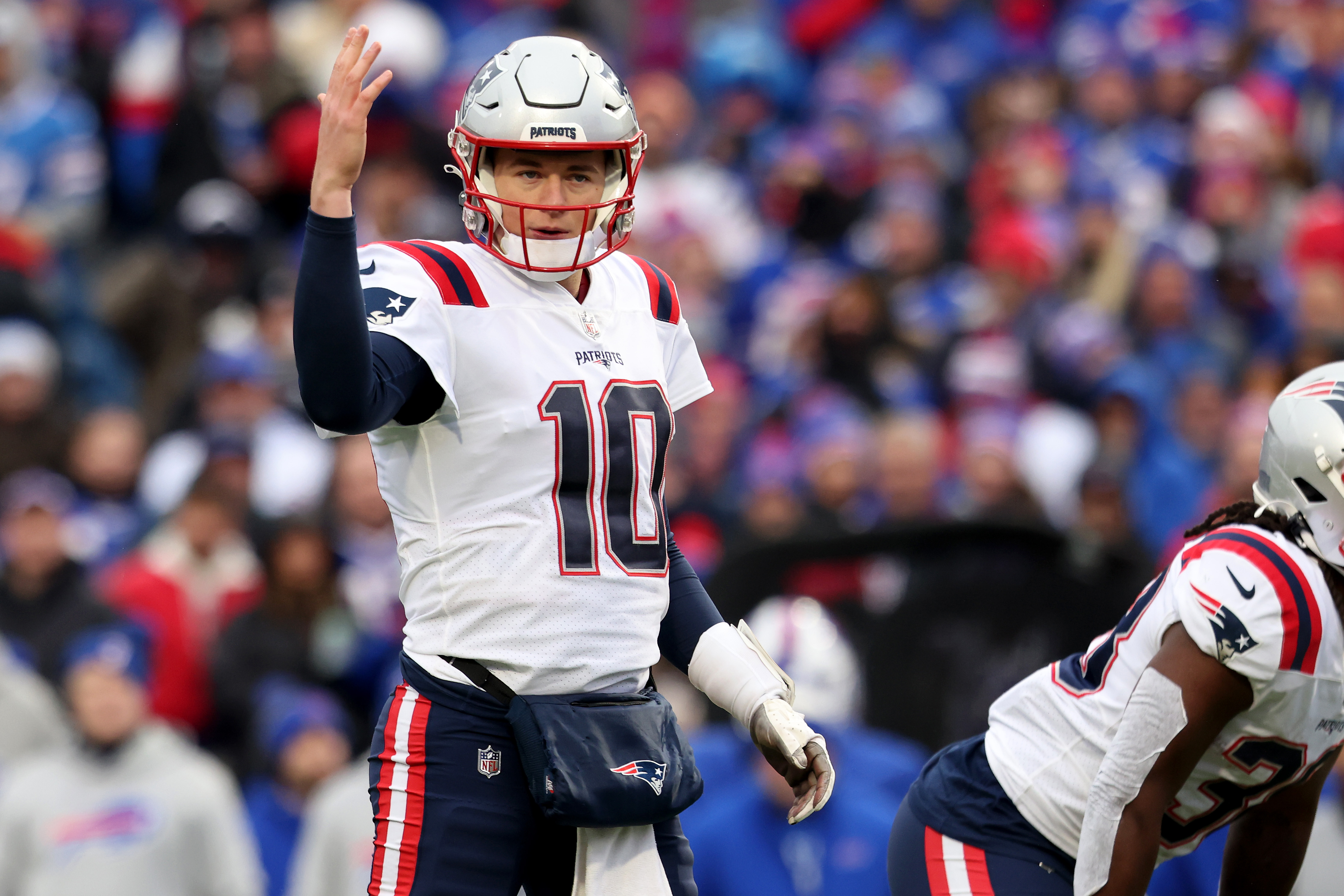 ORCHARD PARK, NEW YORK - JANUARY 08: Mac Jones #10 of the New England Patriots signals during the second quarter against the Buffalo Bills at Highmark Stadium on January 08, 2023 in Orchard Park, New York.