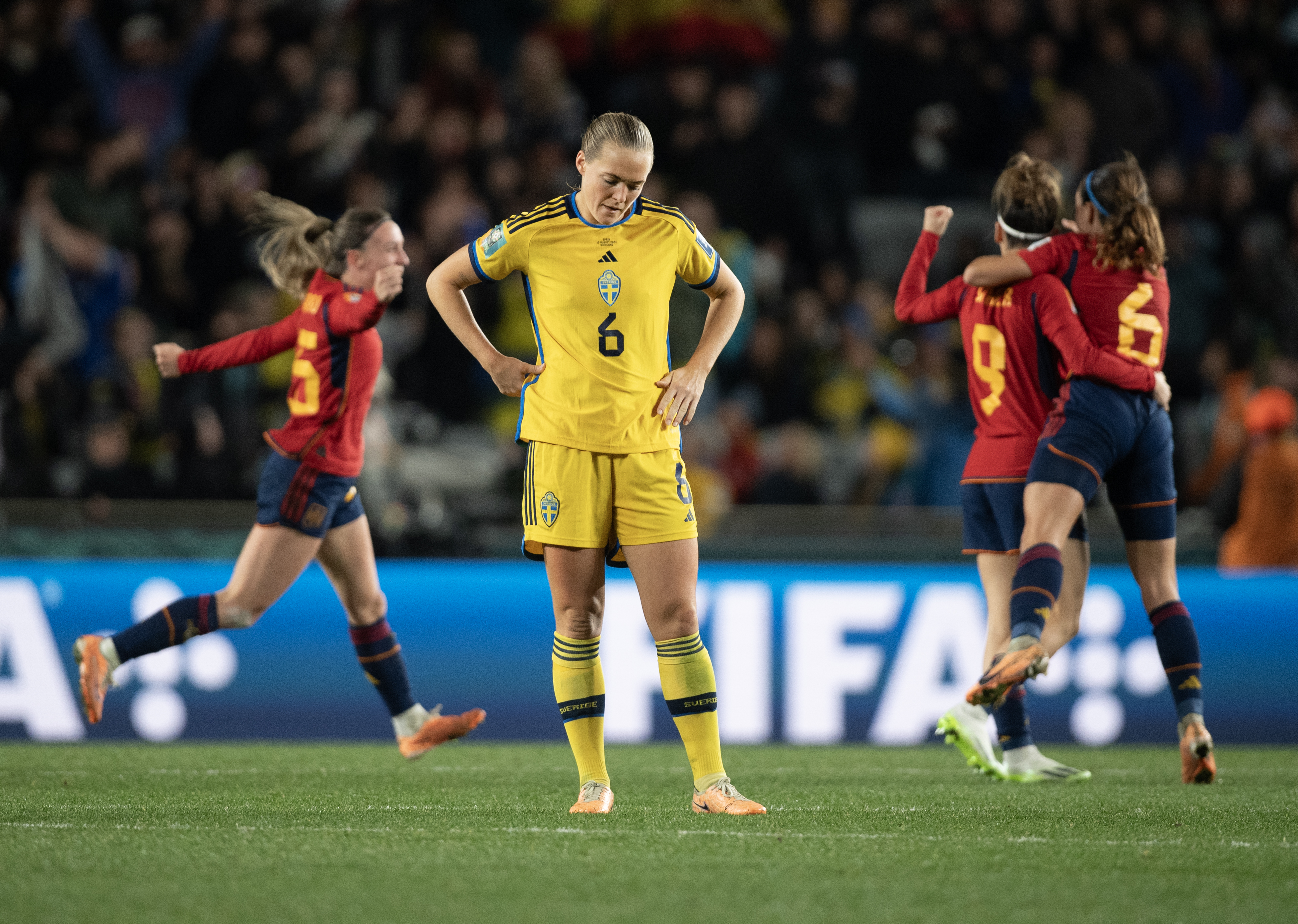 Magdalena Eriksson of Sweden looks dejected while Eva Navarro, Aitana Bonmati and Esther Gonzalez of Spain celebrate after the FIFA Women’s World Cup Australia &amp; New Zealand 2023 Semi Final match between Spain and Sweden at Eden Park on August 15, 2023 in Auckland, New Zealand.
