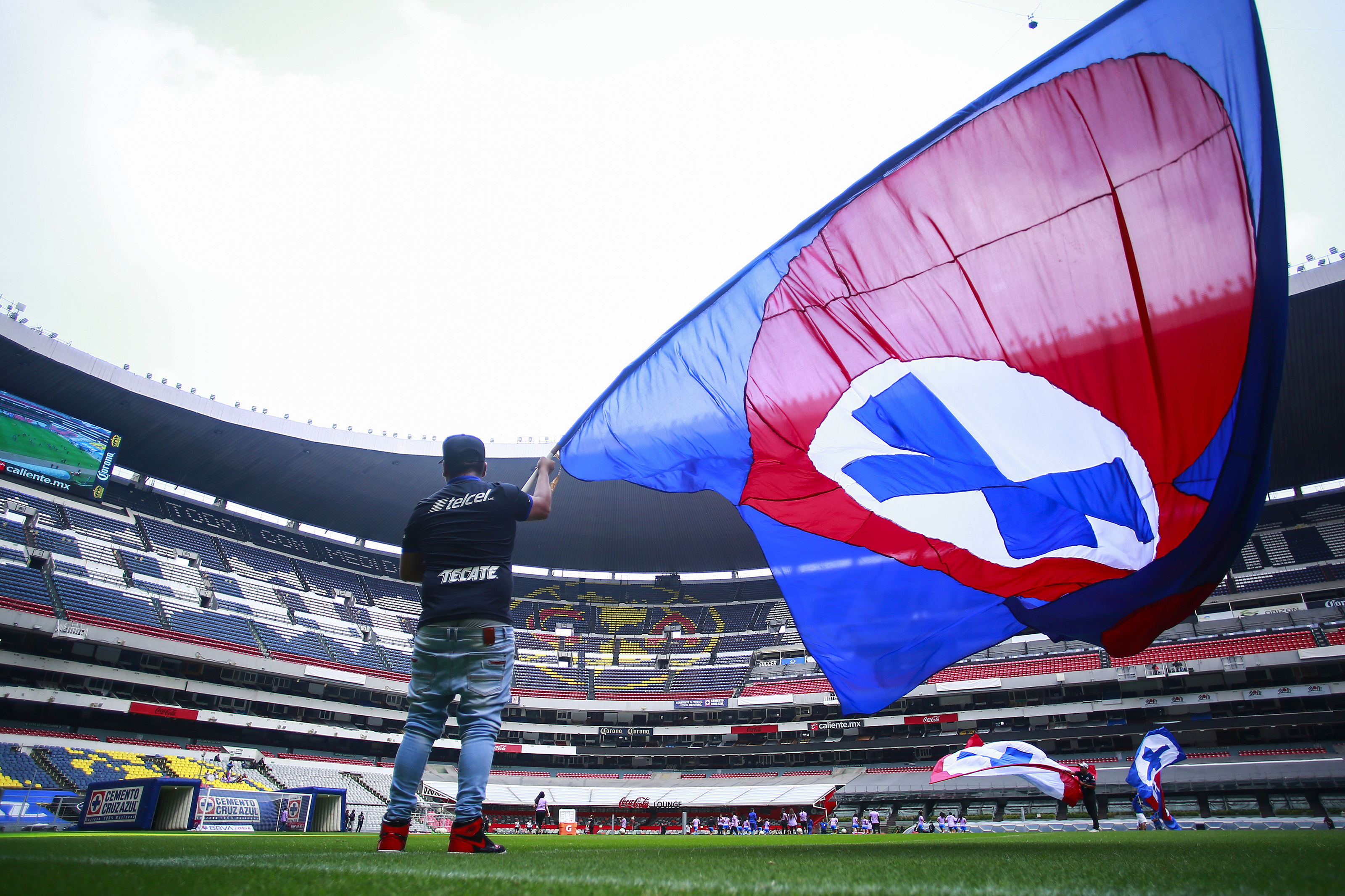 General view of the Azteca stadium with a person waving a large Cruz Azul flag while on the pitch prior a quarterfinal match between Cruz Azul and Chivas as part of Torneo Apertura Liga MX Femenil at Estadio Azteca on October 27, 2022 in Mexico City, Mexico.