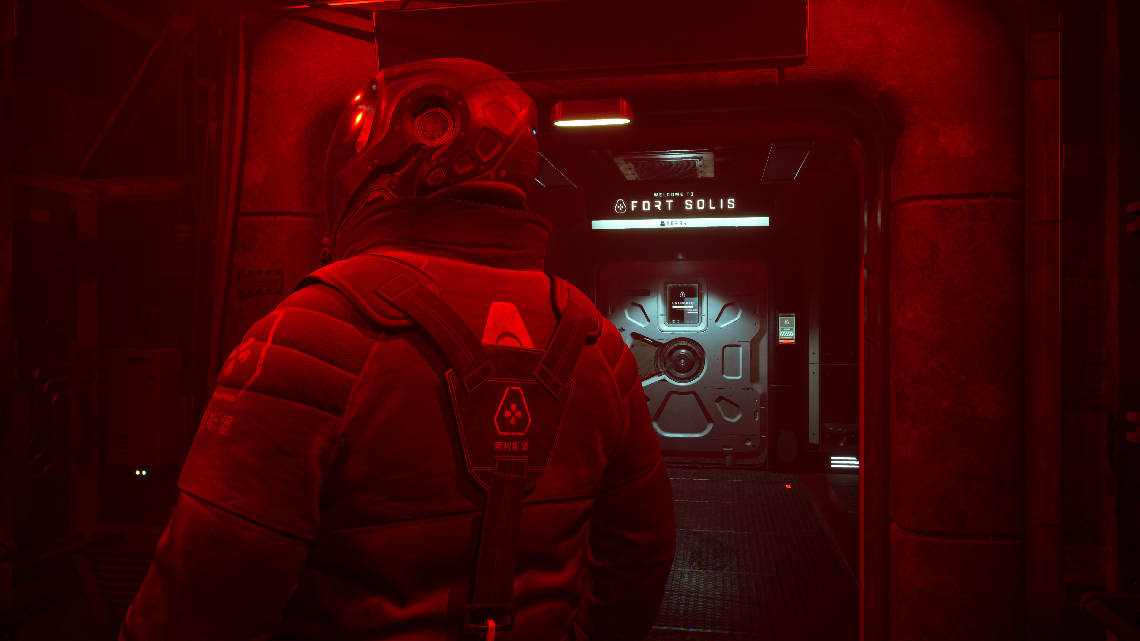 A person in a space suit looking at a wall panel in Fort Solis. The scene is bathed in red light.