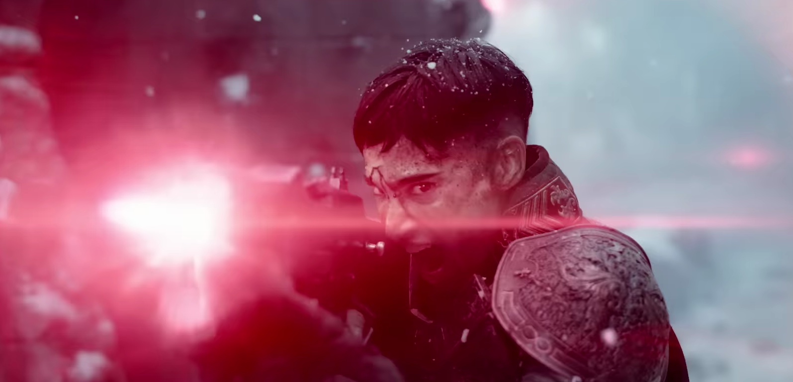 A dark-haired character in intricate armor fires a beam weapon that produces a bright pink light in Zack Snyder’s Rebel Moon