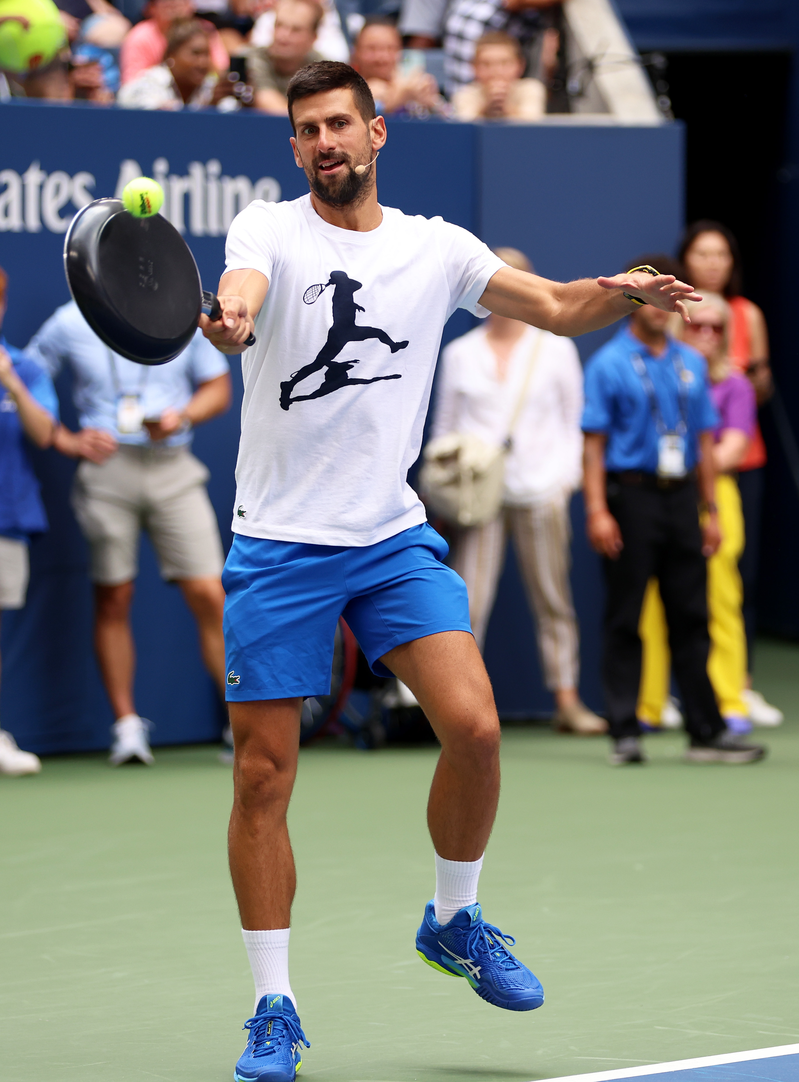 Novak Djokovic of Serbia plays tennis with a frying pa as a racket during Arthur Ashe Kids’ Day at USTA Billie Jean King National Tennis Center on August 26, 2023 in New York City.