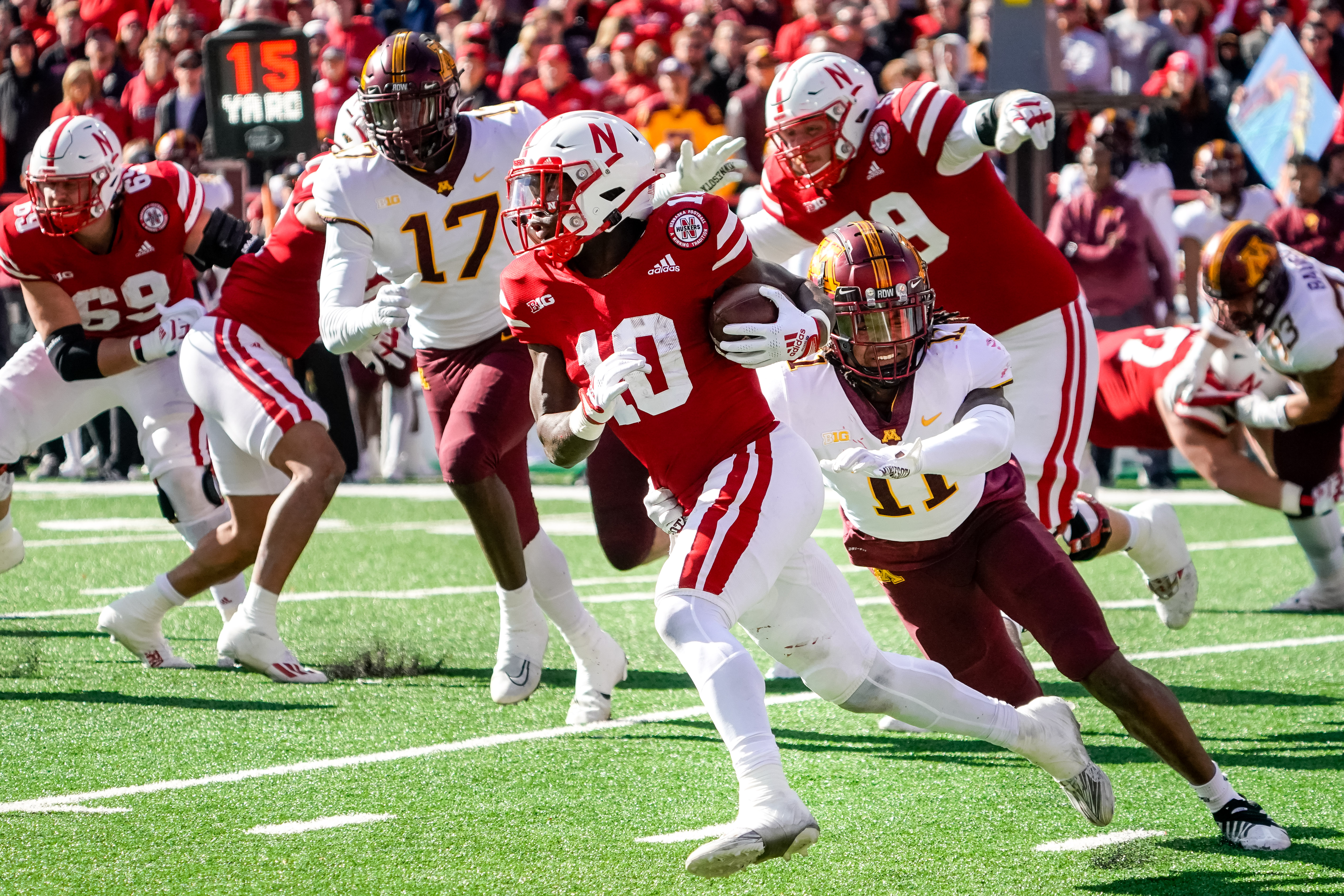 Nebraska Cornhuskers running back Anthony Grant (10) runs with the ball as Minnesota Golden Gophers defensive back Michael Dixon (11) attempts a tackle during the fourth quarter at Memorial Stadium.