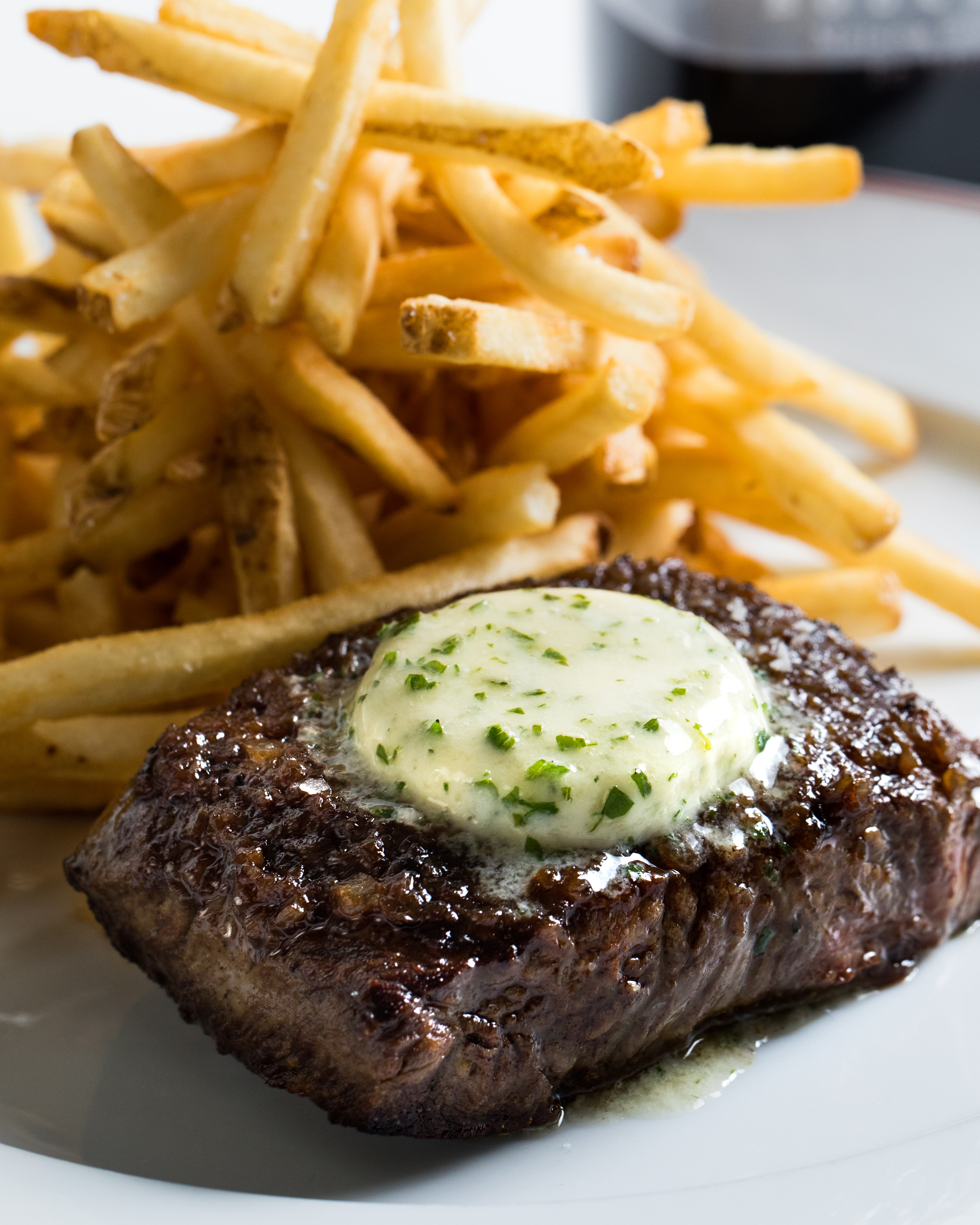 steak on plate with fries.
