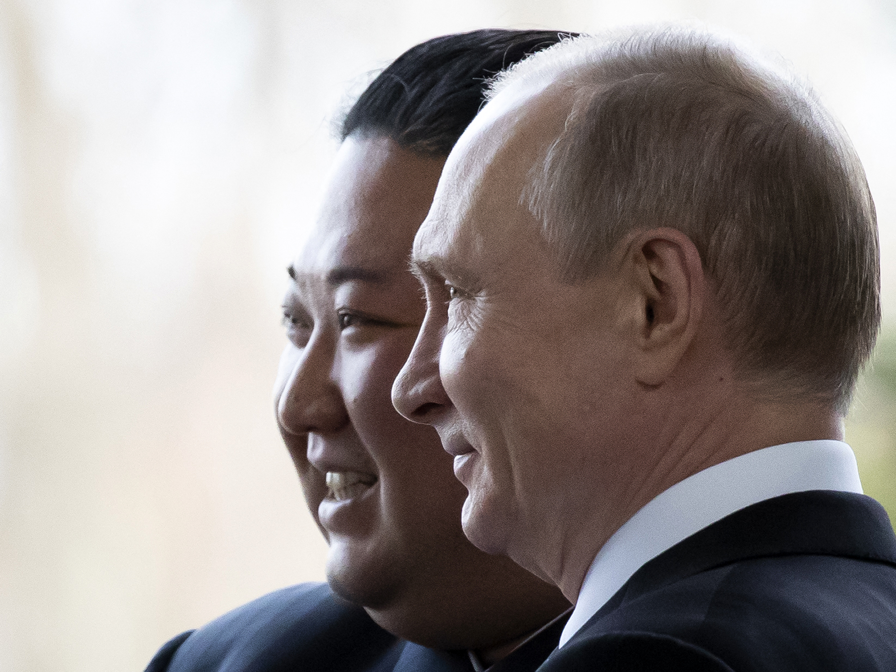 Vladimir Putin and Kim Jong Un, in profile, next to each other.