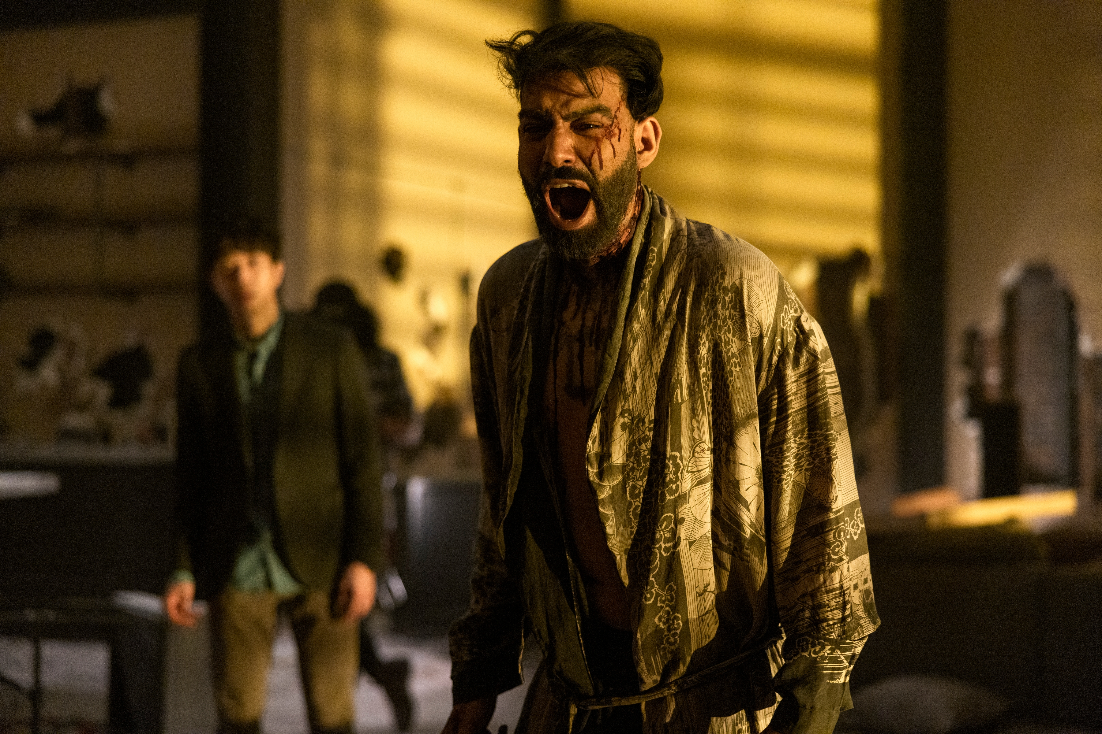(L-R) Daniel Jun as Julius, Rahul Kohli as Napoleon Usher screaming in a robe covered in blood in The Fall of the House of Usher.