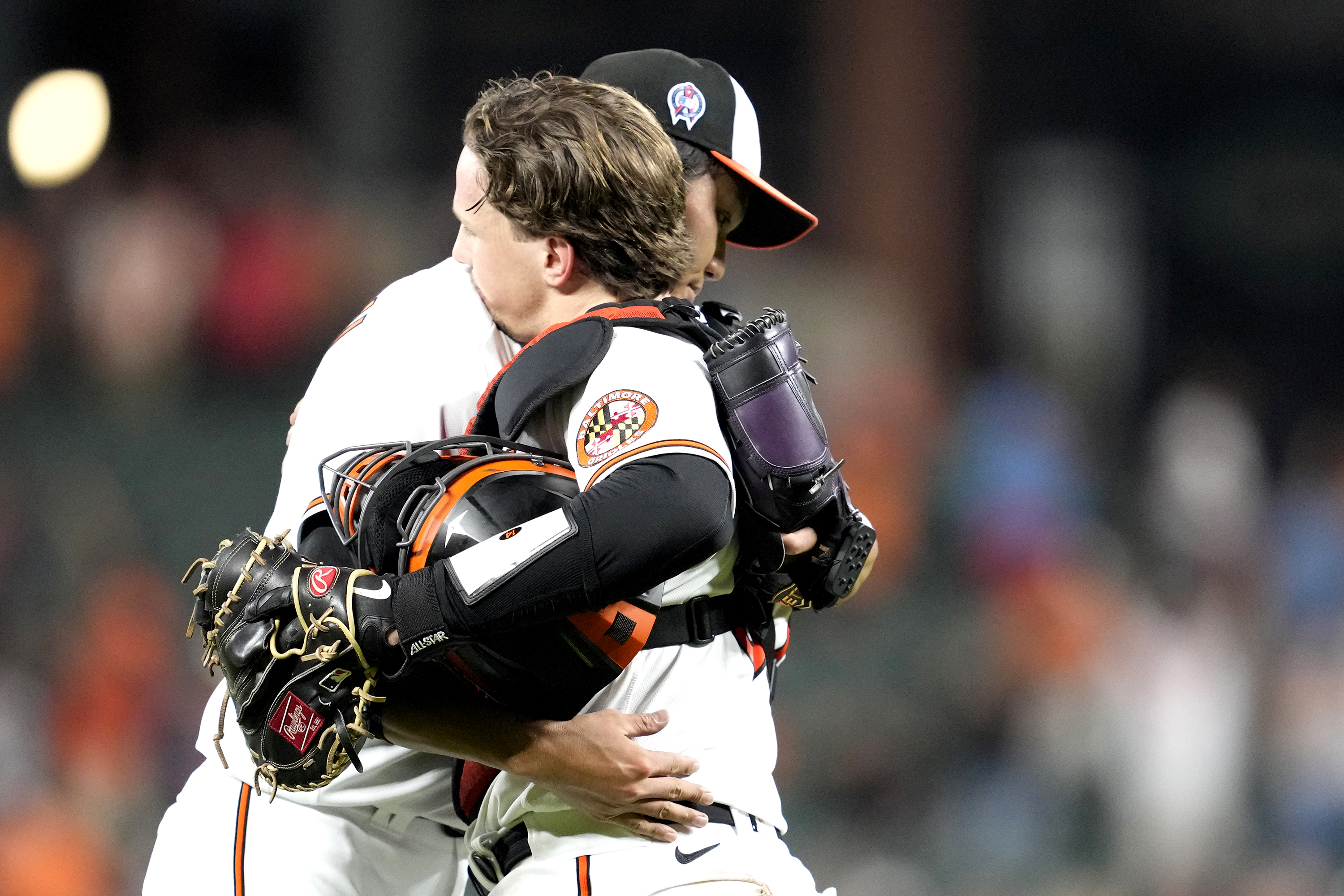 Shintaro Fujinami of the Baltimore Orioles celebrates a win after a baseball game with Adley Rutschman against the St. Louis Cardinals at Oriole Park at Camden Yards on September 11, 2023 in Baltimore, Maryland.