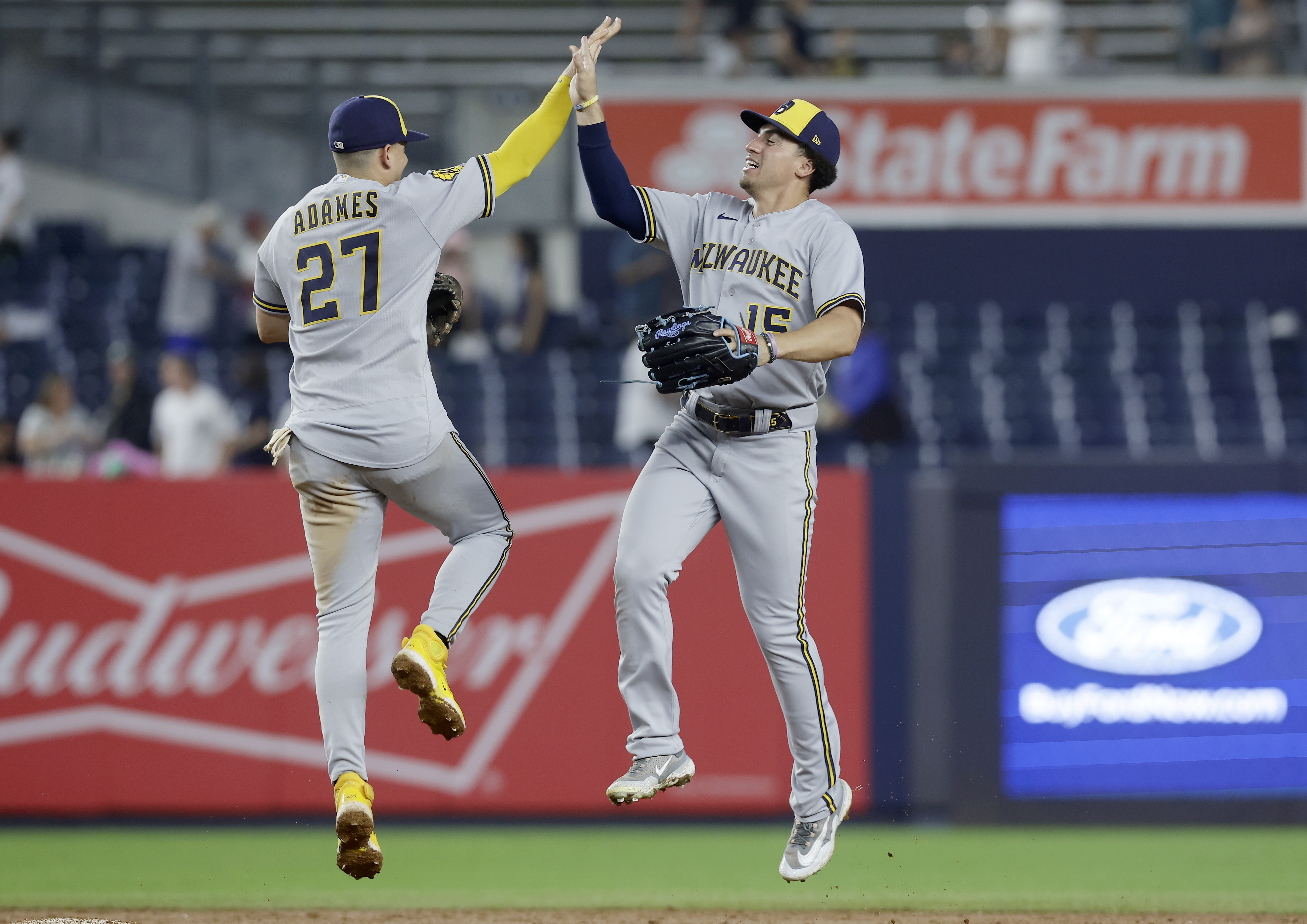 Willy Adames and Tyrone Taylor of the Milwaukee Brewers celebrate after defeating the New York Yankees at Yankee Stadium on September 9, 2023 in the Bronx borough of New York City.