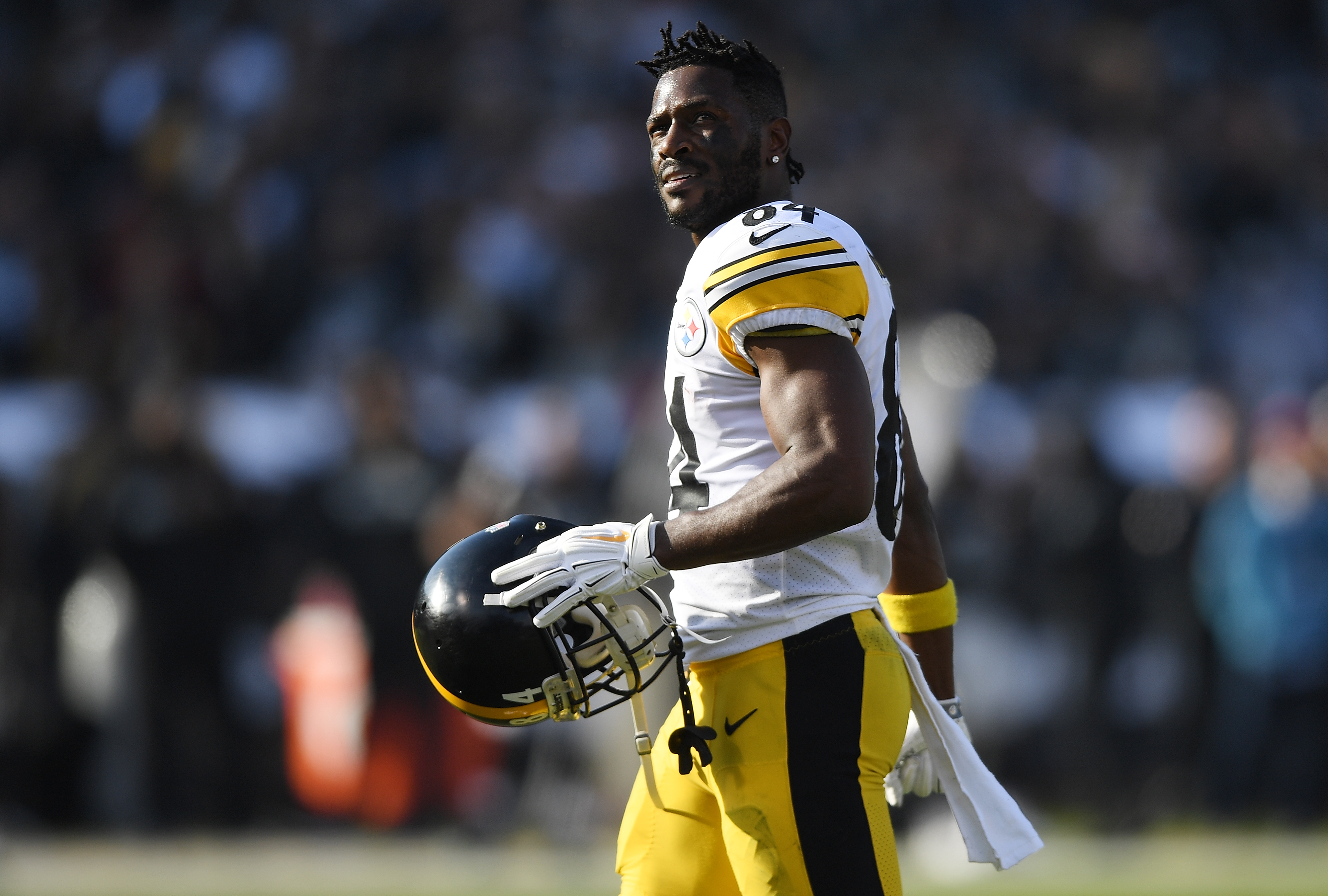 Antonio Brown #84 of the Pittsburgh Steelers looks on as he walks onto the field against the Oakland Raiders during the first half of their NFL football game at Oakland-Alameda County Coliseum on December 9, 2018 in Oakland, California.