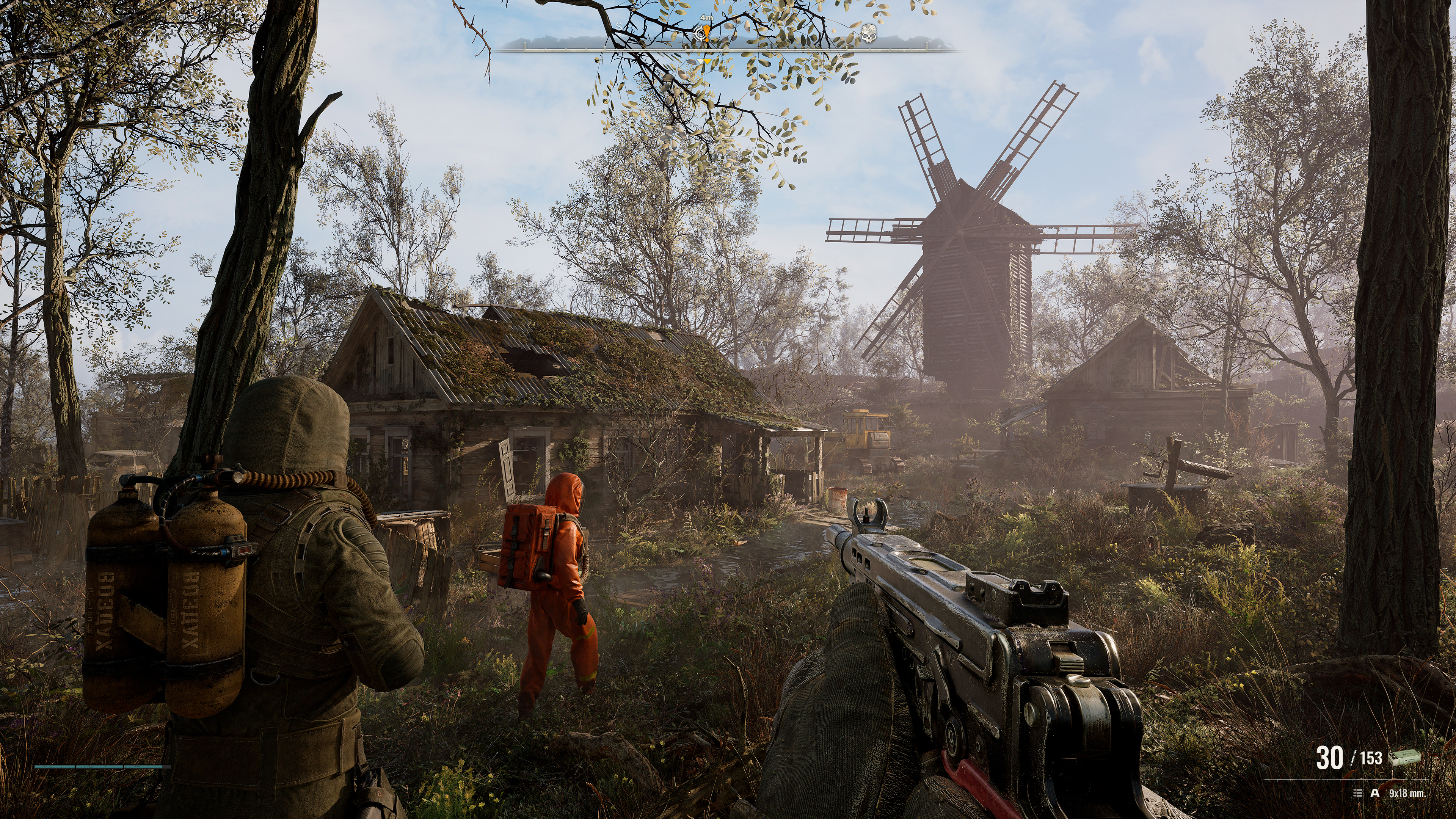 The first-person player character keeps their assault rifle at the ready, following two other armed characters in full-body protective gear towards a thickly overgrown cottage and windmill in STALKER 2