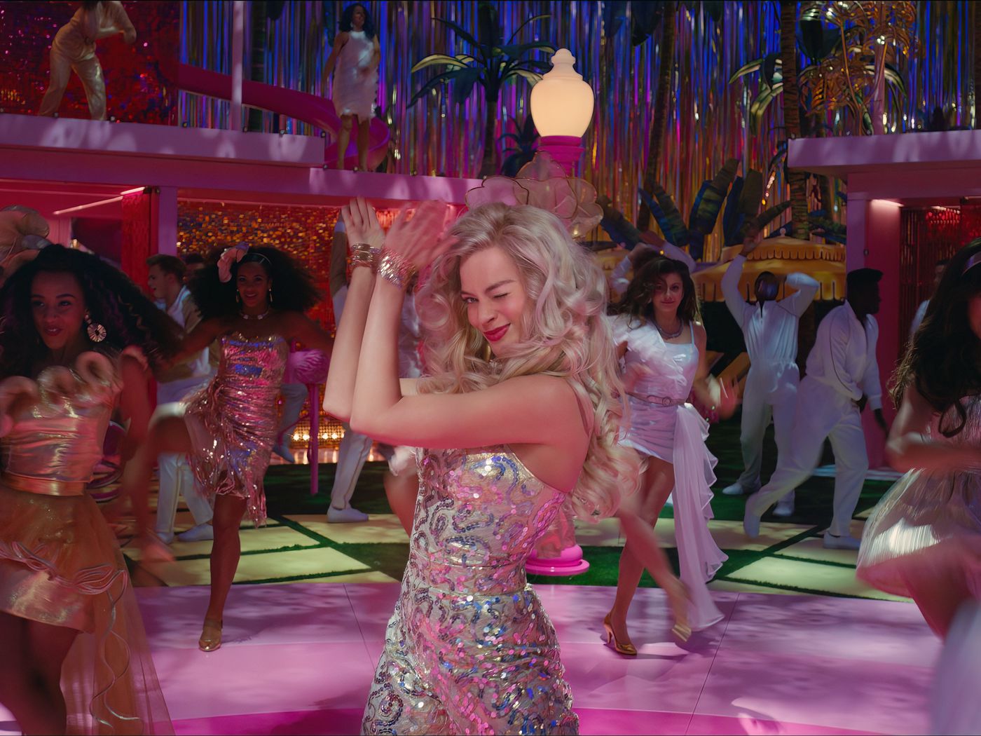 Margot Robbie as Barbie, clapping and dancing in an elaborate musical sequence in Barbie.