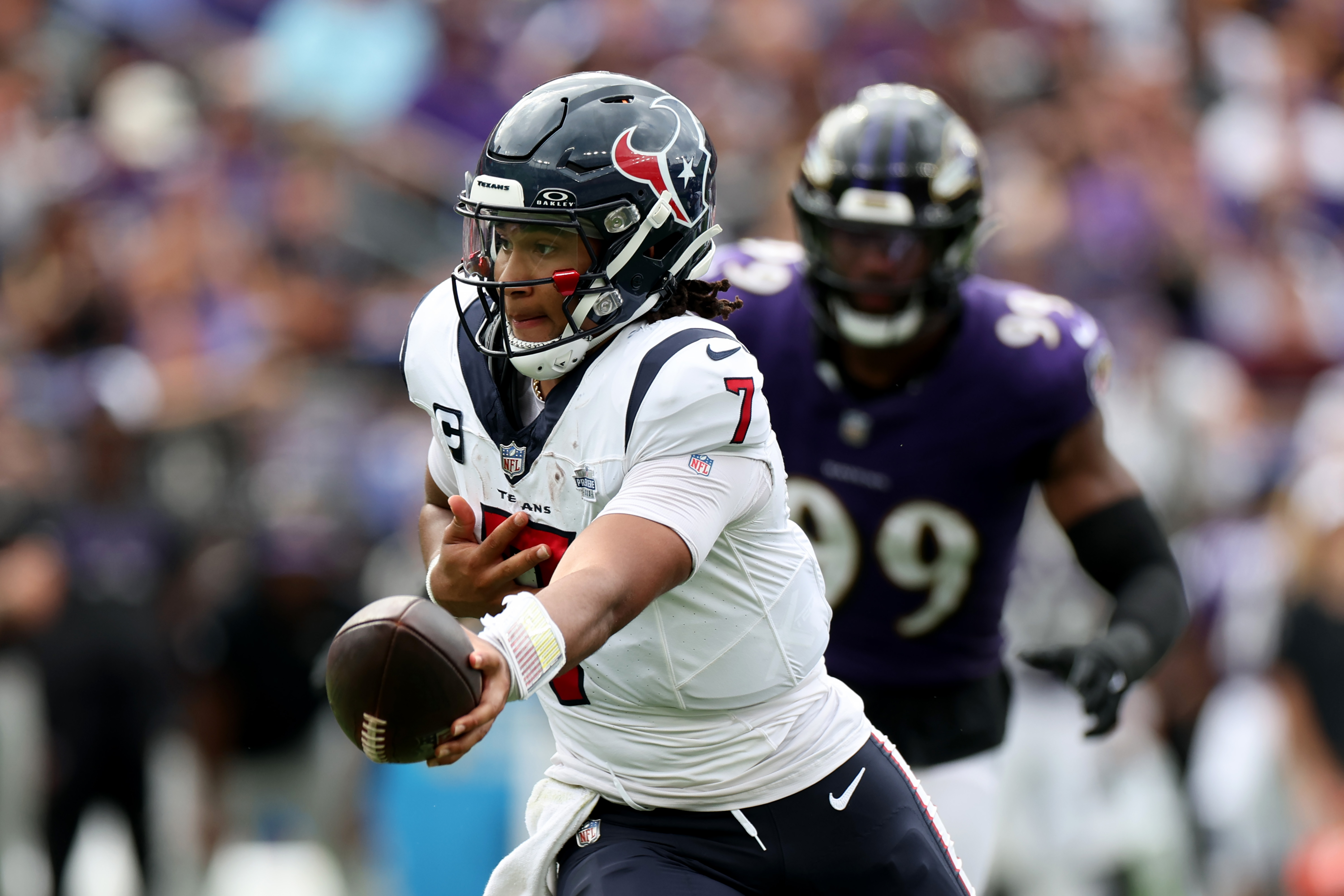 Quarterback C.J. Stroud of the Houston Texans hands the ball off against the Baltimore Ravens at M&amp;T Bank Stadium on September 10, 2023 in Baltimore, Maryland.