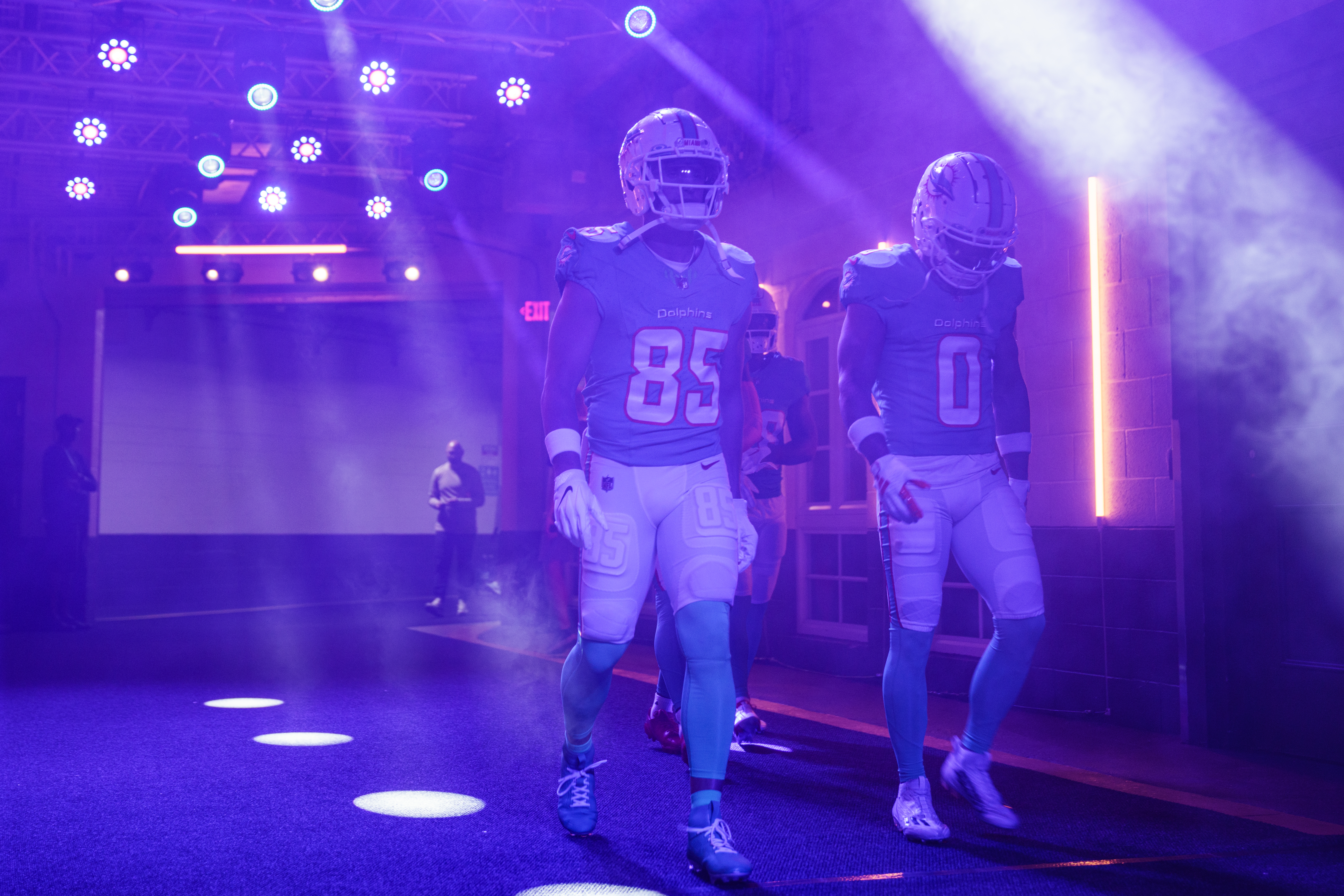 Wide receiver River Cracraft of the Miami Dolphins (L) and wide receiver Braxton Berrios (R) of the Miami Dolphins walk through the stadiums tunnel and out onto the field before a preseason game agains the Atlanta Falcons at Hard Rock Stadium on August 11, 2023 in Miami Gardens, Florida.