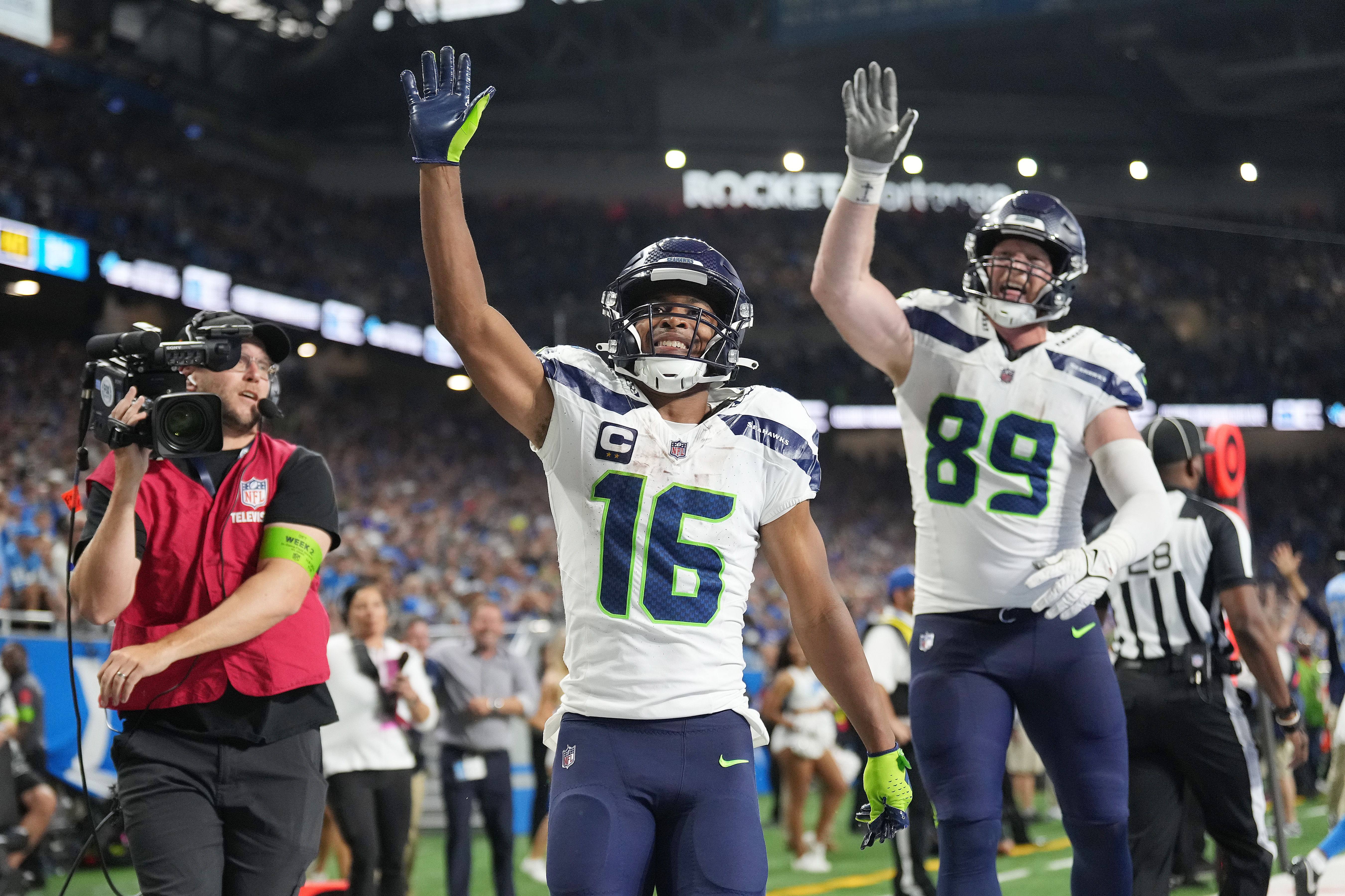 Tyler Lockett #16 and Will Dissly #89 of the Seattle Seahawks celebrates a win over the Detroit Lions at Ford Field on September 17, 2023 in Detroit, Michigan.