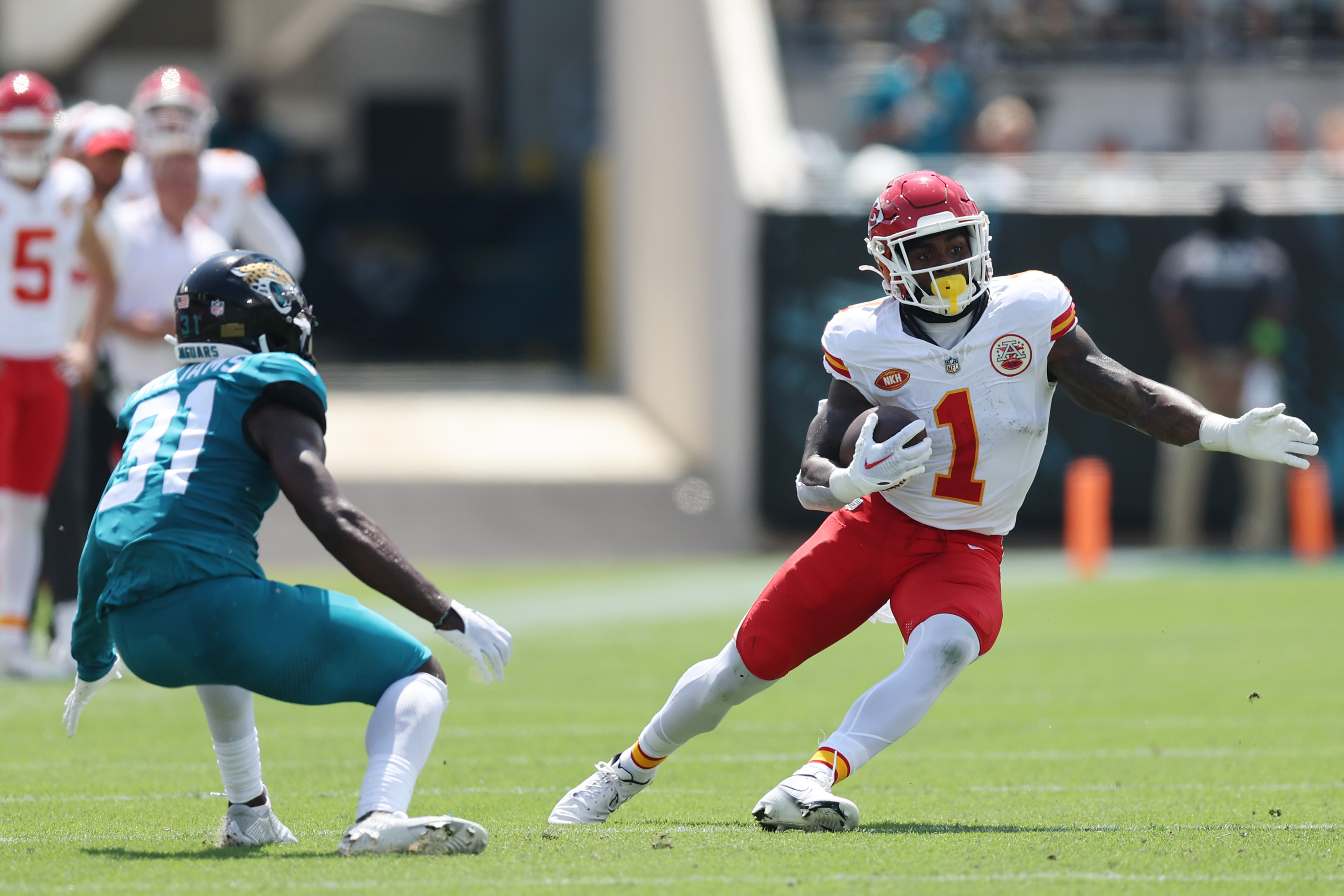 Jerick McKinnon of the Kansas City Chiefs runs with the ball against Darious Williams of the Jacksonville Jaguars during the second quarter at EverBank Stadium on September 17, 2023 in Jacksonville, Florida.