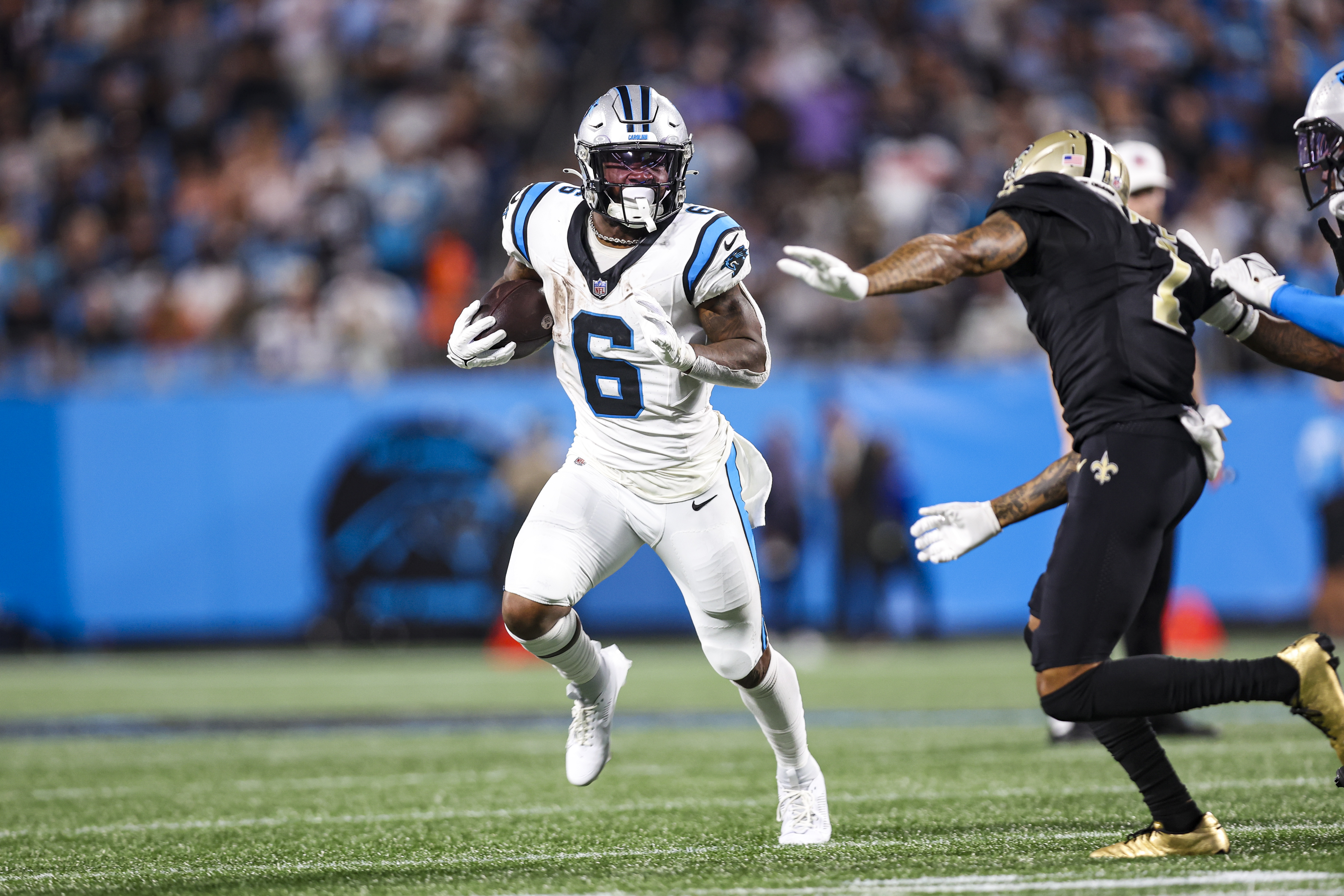 Miles Sanders #6 of the Carolina Panthers runs the ball during an NFL football game against the New Orleans Saints at Bank of America Stadium on September 18, 2023 in Charlotte, North Carolina.