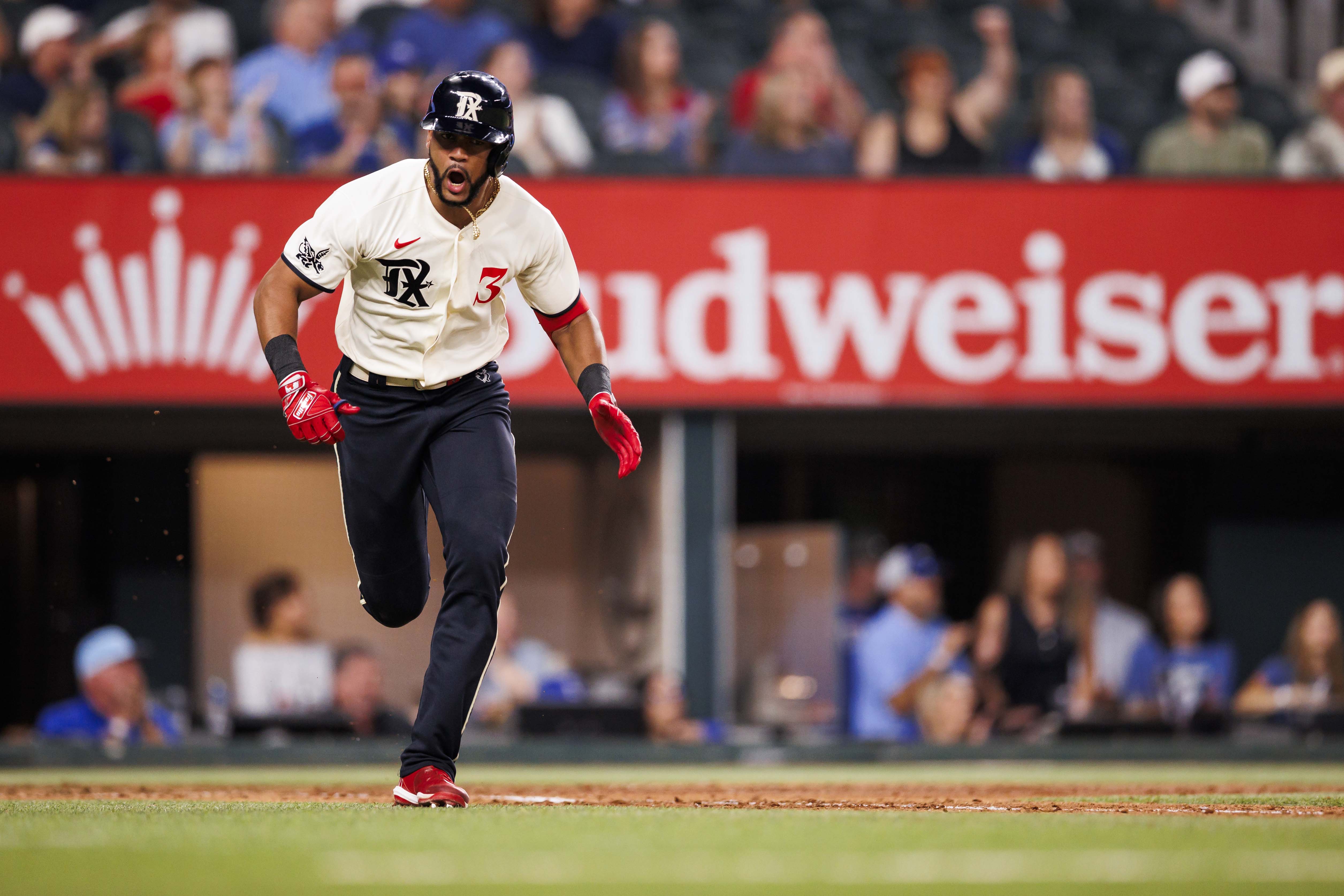 Leody Taveras of the Texas Rangers celebrates while running to first base during a game against the Oakland Athletics at Globe Life Field on September 09, 2023 in Arlington, Texas.