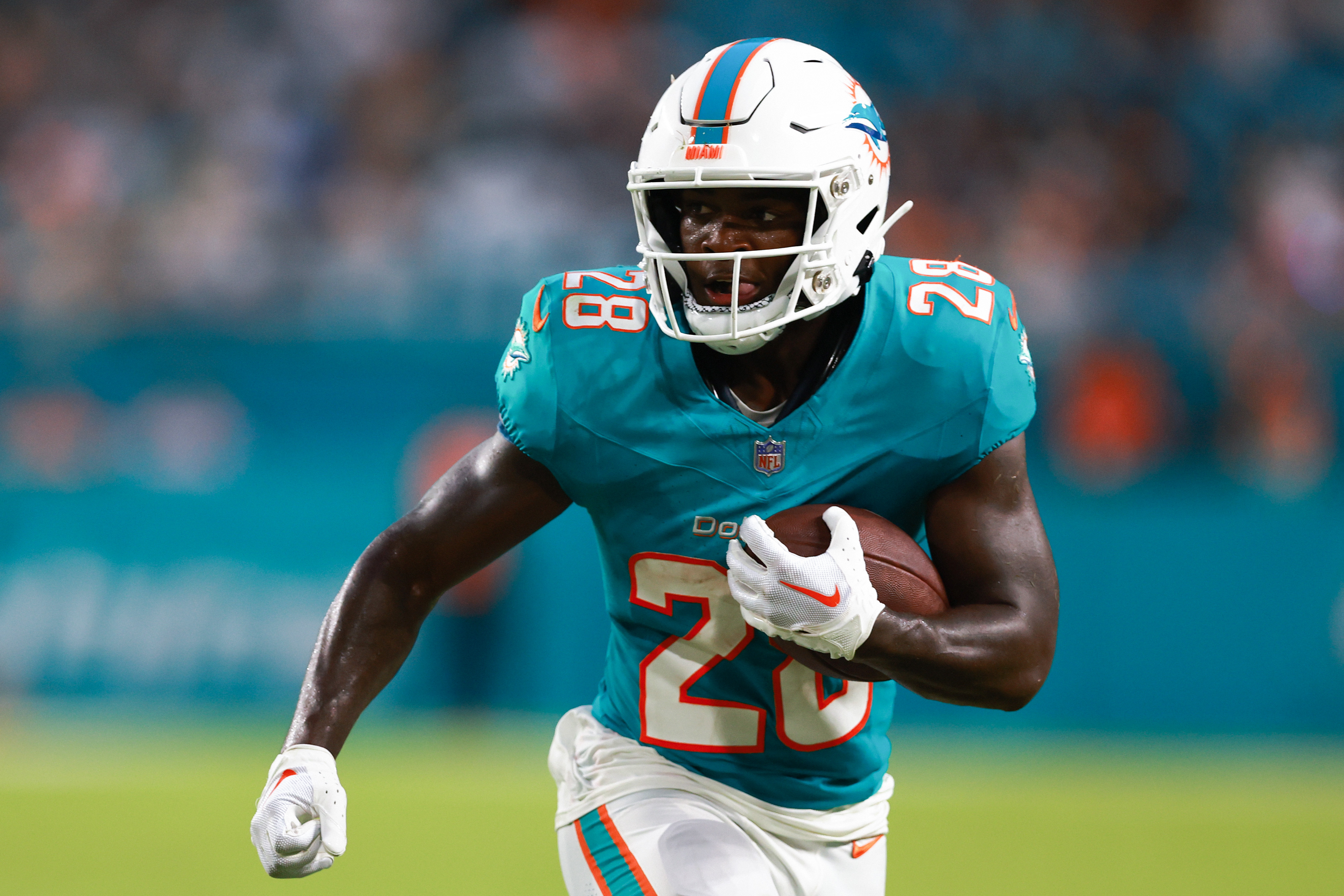 MIAMI GARDENS, FLORIDA - AUGUST 11: De’Von Achane #28 of the Miami Dolphins carries the ball against the Atlanta Falcons during the second quarter in a preseason game at Hard Rock Stadium on August 11, 2023 in Miami Gardens, Florida.