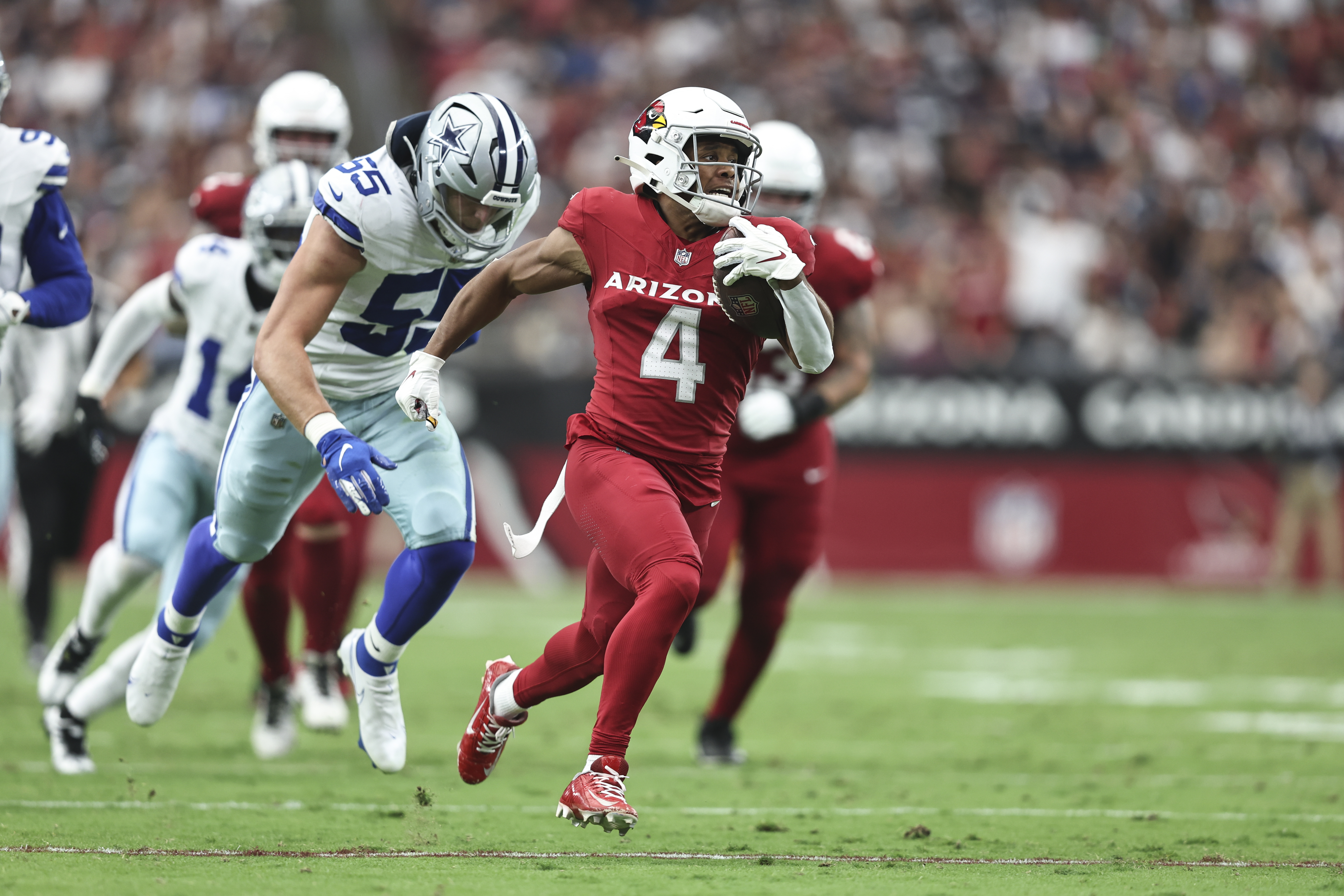 Rondale Moore #4 of the Arizona Cardinals runs with the ball for a touchdown during an NFL football game between the Arizona Cardinals and the Dallas Cowboys at State Farm Stadium on September 24, 2023 in Glendale, Arizona.