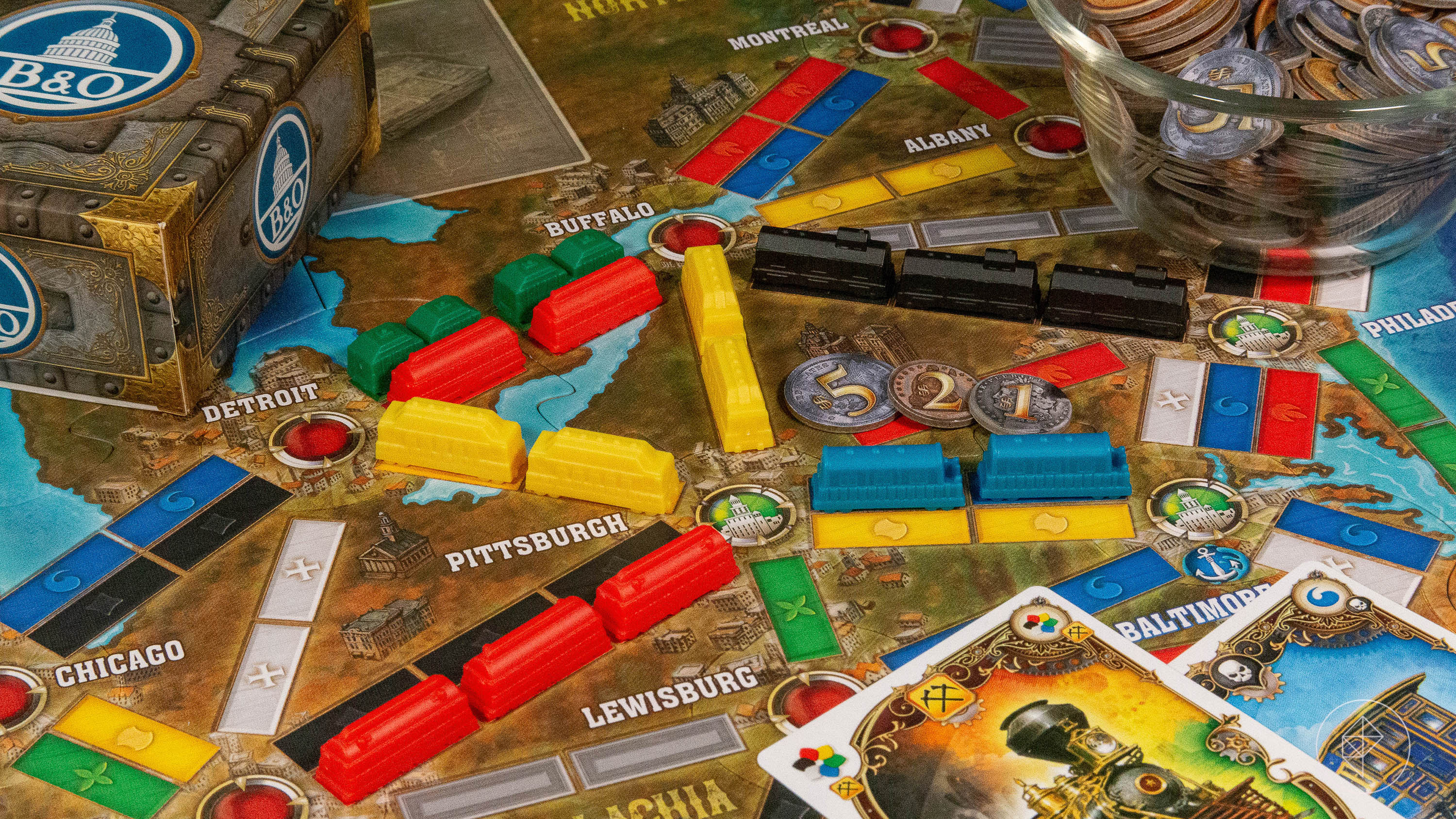 Colorful train cars deployed on the game board for Ticket to Ride Legacy: Legends of the West.